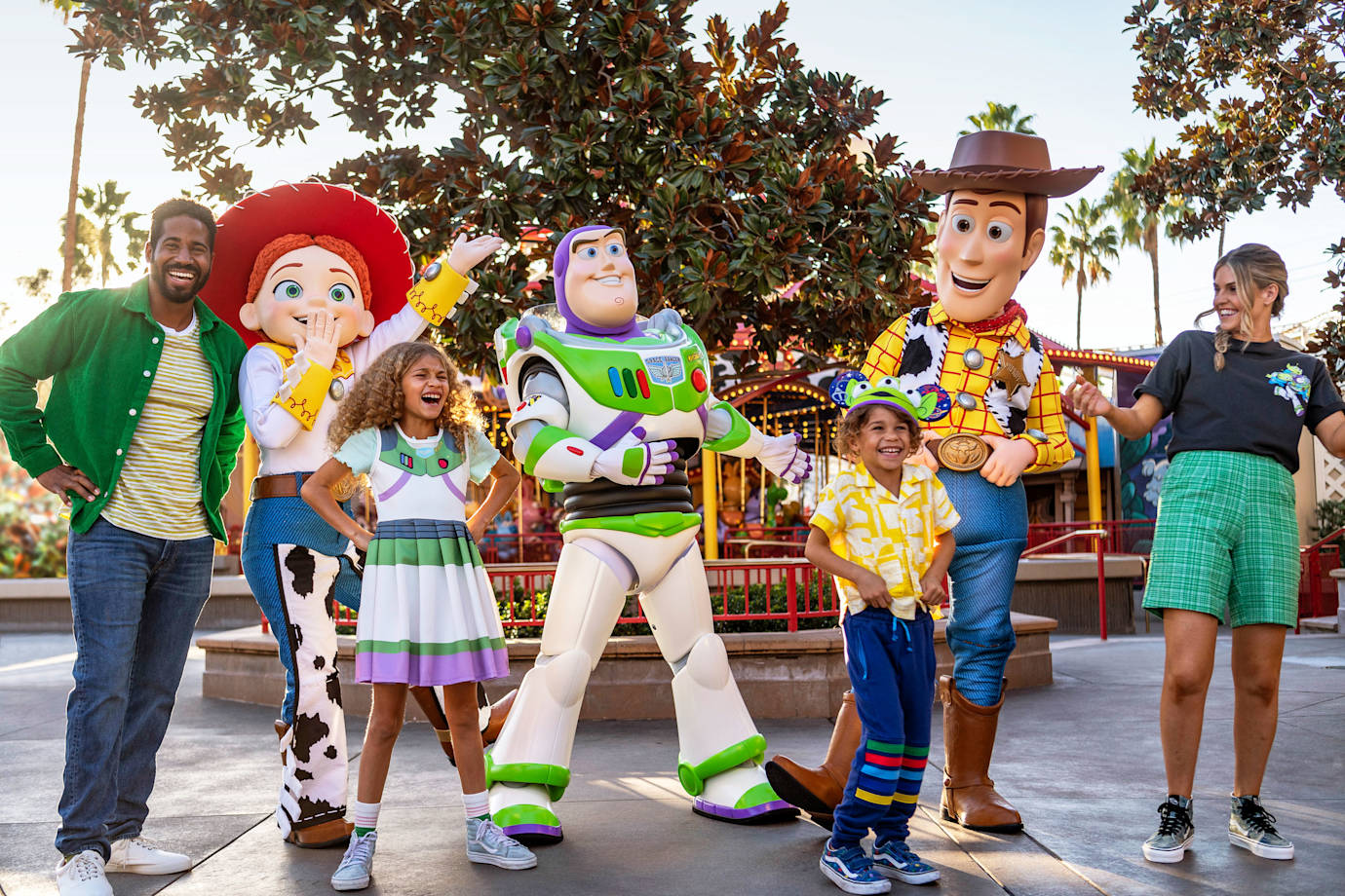 A family poses with characters from Toy Story at Disneyland Resort.
