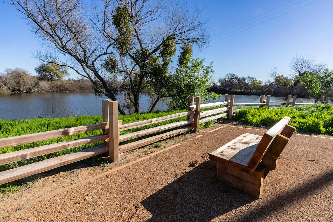 A bench overlooks the pond at Dos Rios State Park in California.
