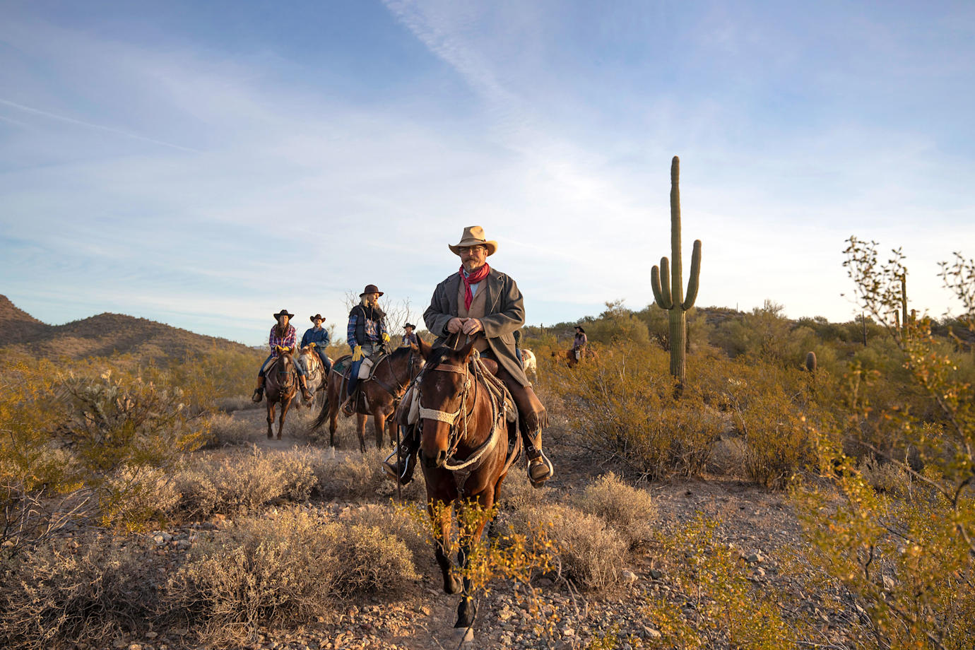 A group of riders meander through the desert at Kay El Bar Guest Ranch in Arizona.