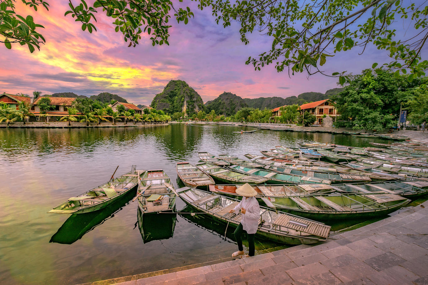 Row boats waiting for passengers at sunrise at Hoa Lu Tam Coc, Hoi An Ancient Town in Vietnam.