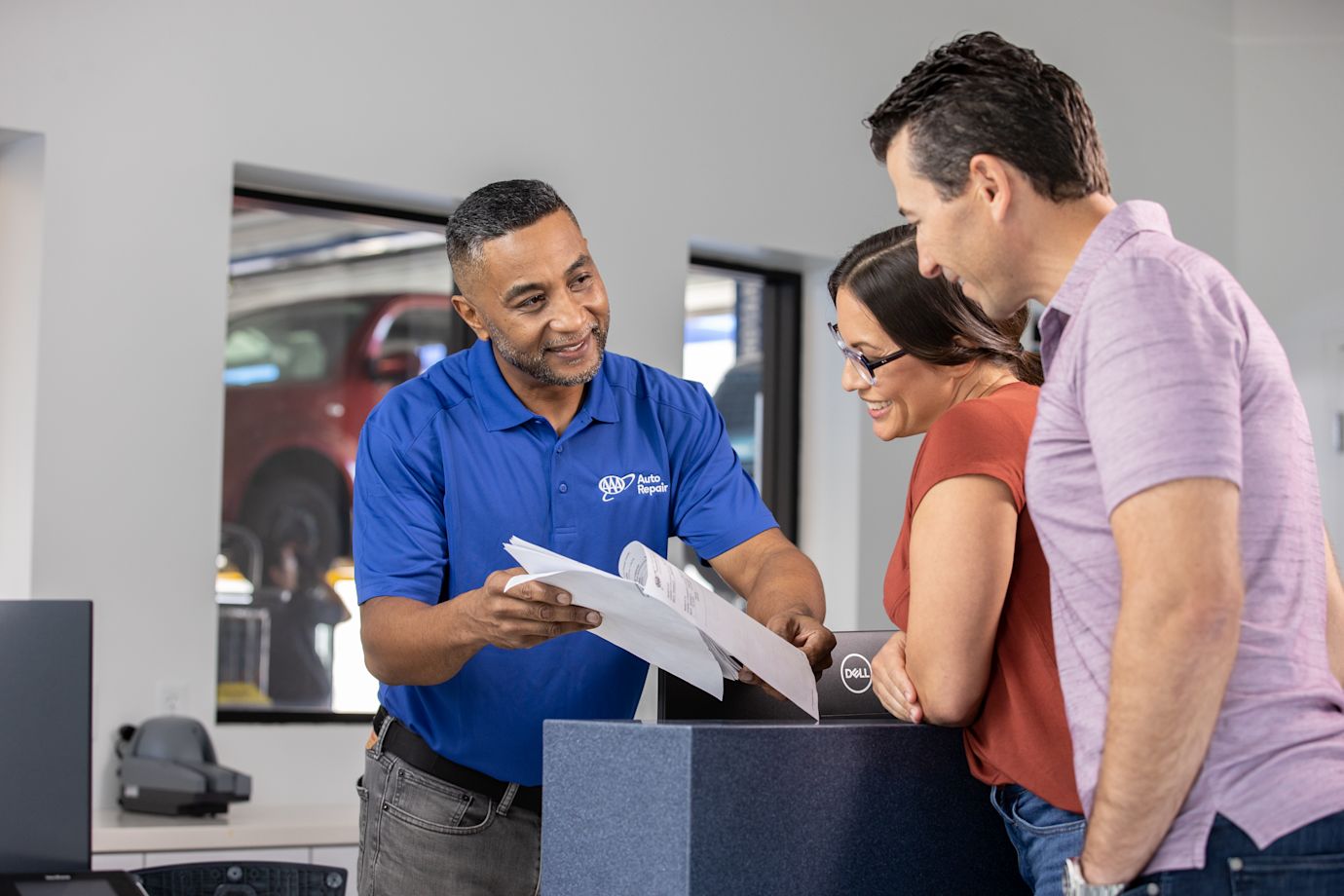 AAA service advisor helping a couple