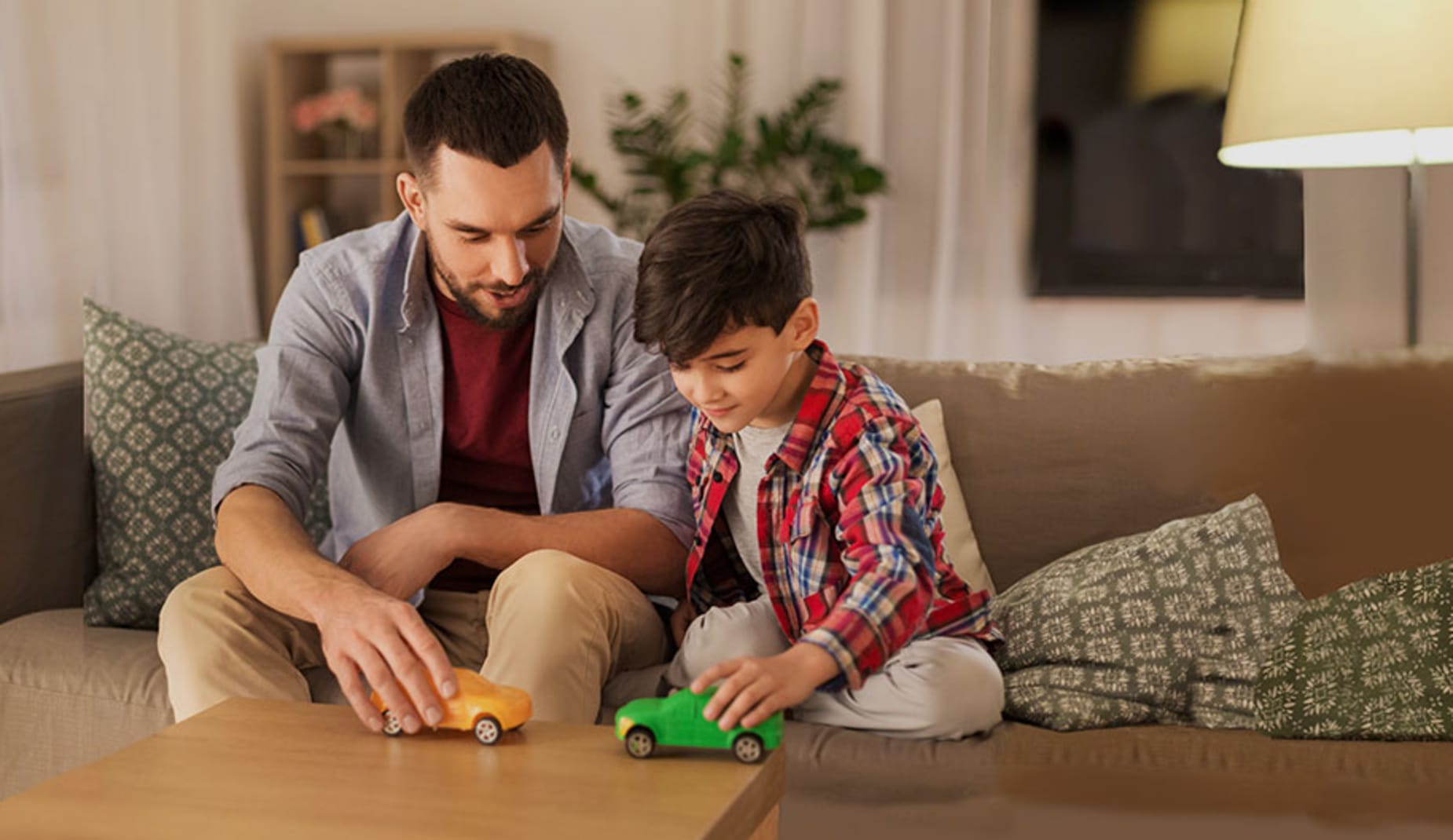 Dad and son playing with toy cars