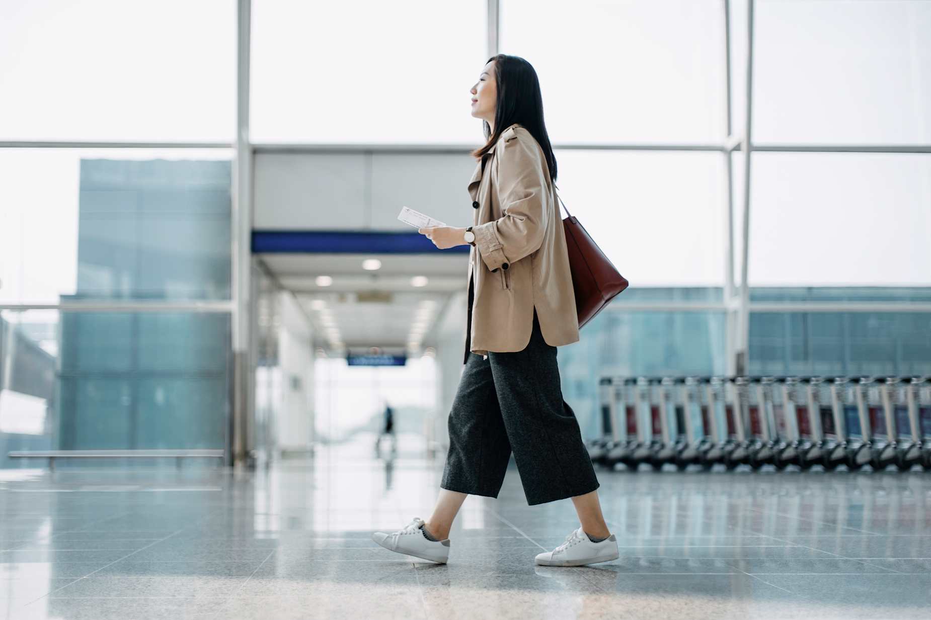A traveler with TSA PreCheck through CLEAR and verified by AAA walks to their gate at the airport