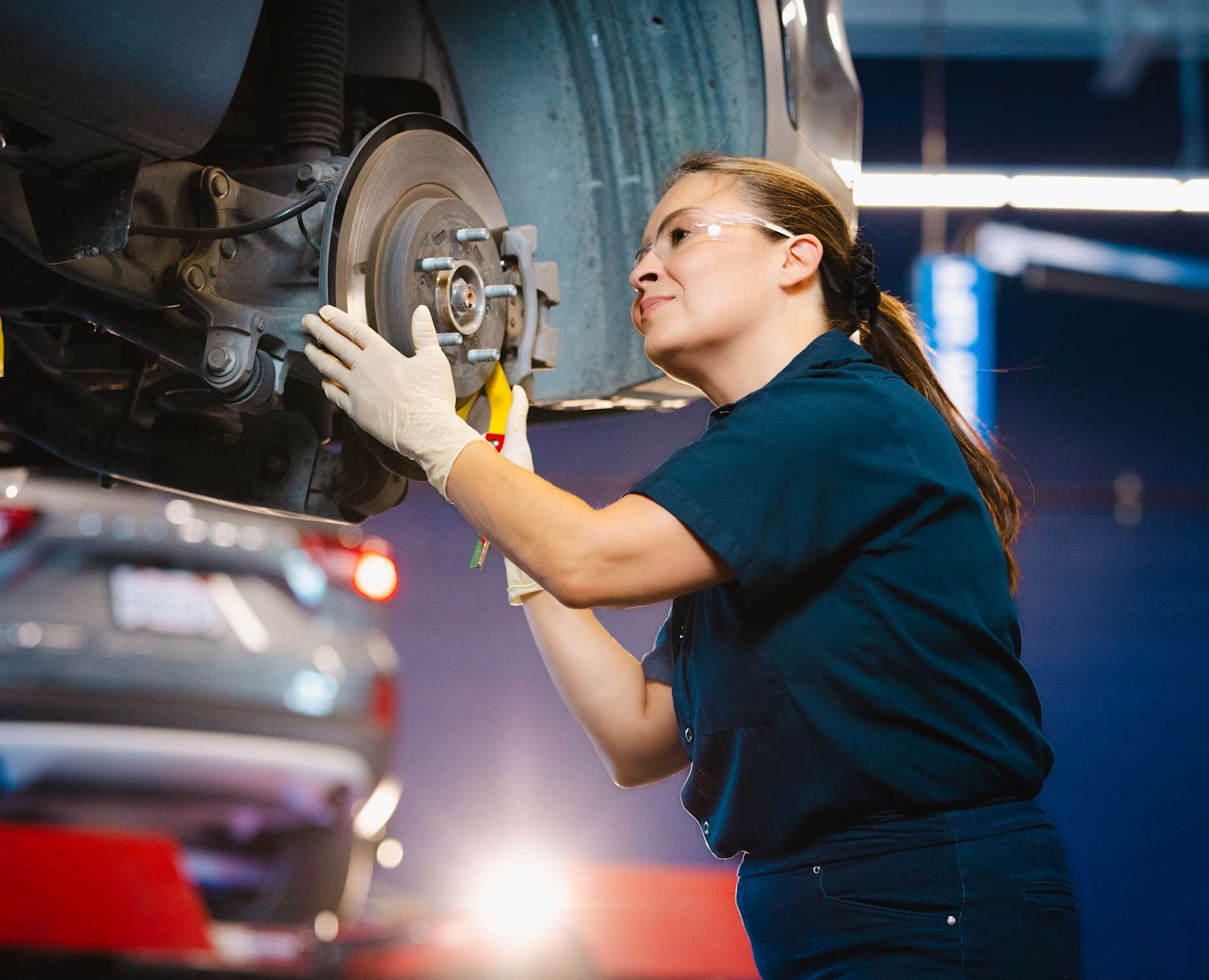AAA Auto Repair mechanic looks at a wheel