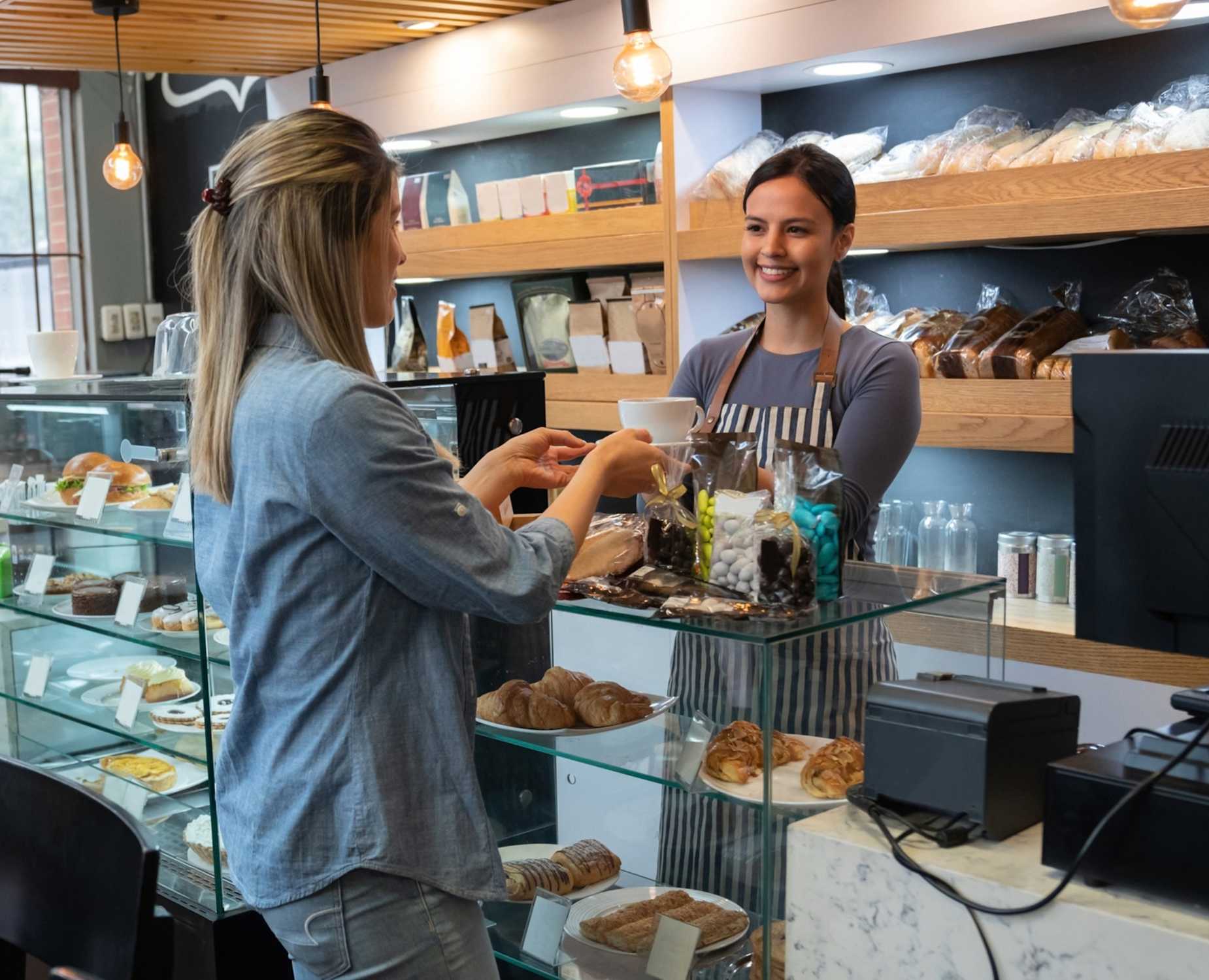 Woman buys coffee at a local cafe