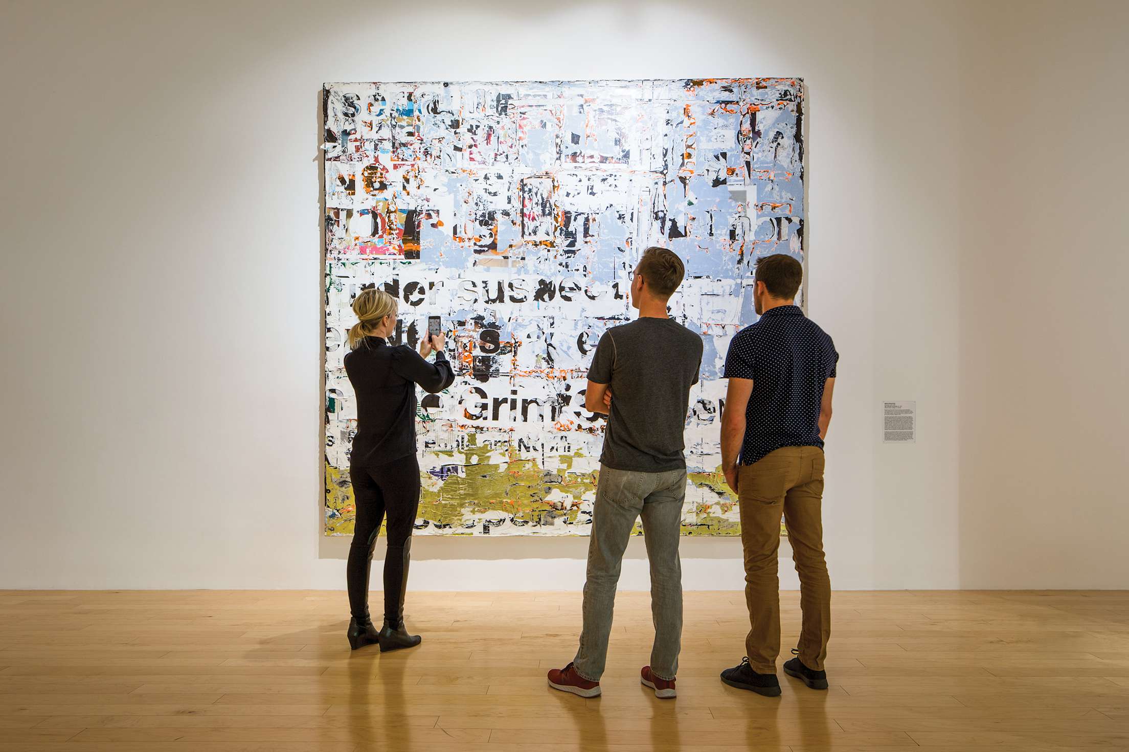 visitors to the Palm Springs Art Museum examine a work of art