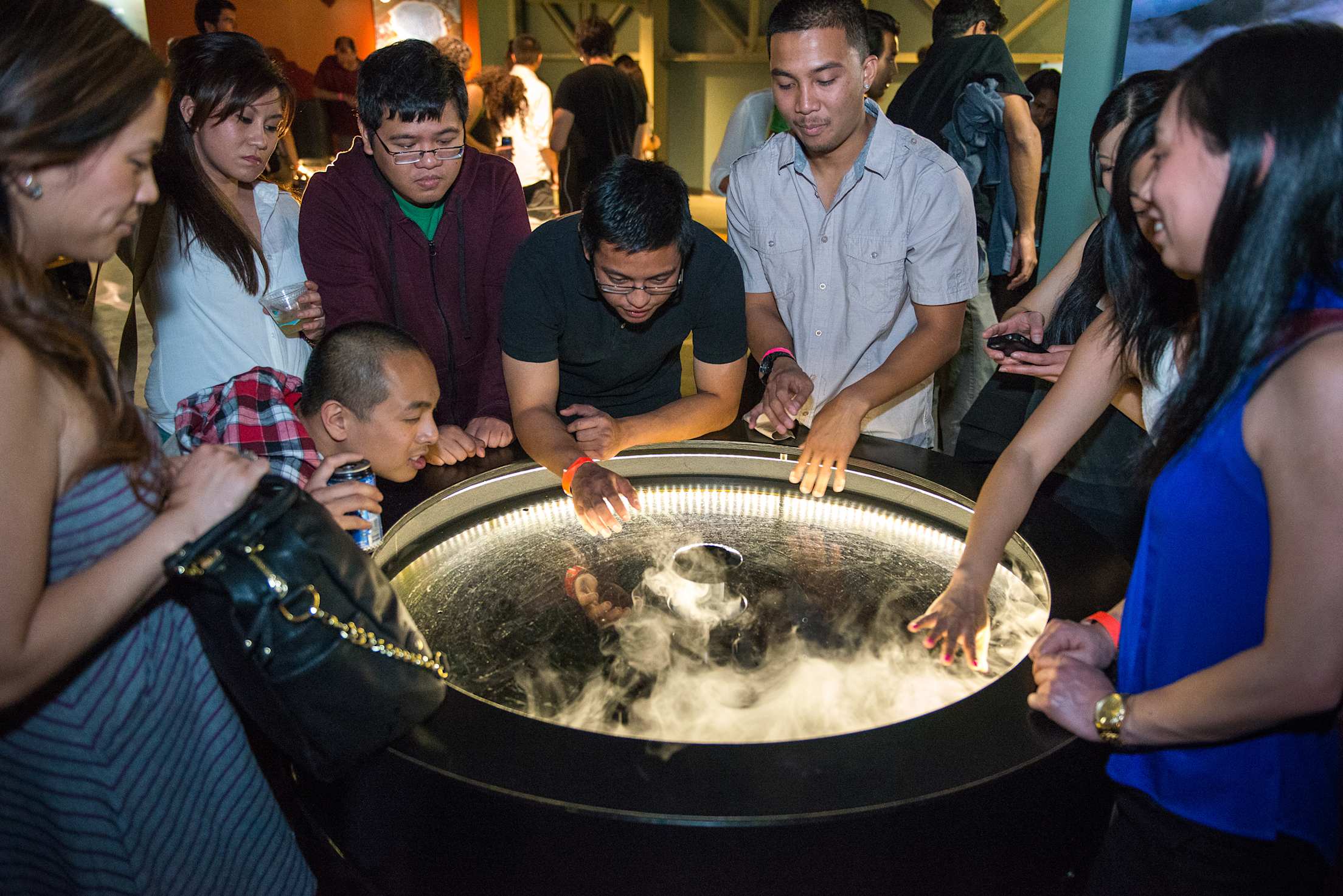 Crowd of people viewing interactive exhibit at San Francisco Exploratorium, photo