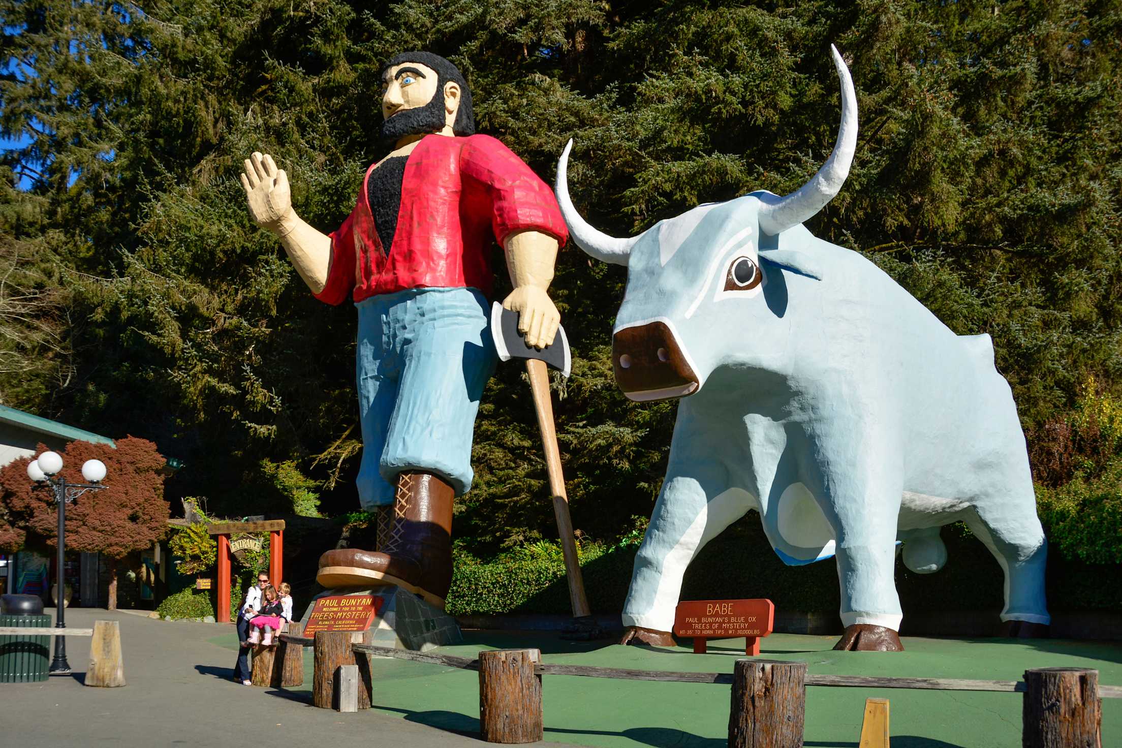 Paul Bunyan waves and leans on his ax beside Babe the Blue Ox, in Klamath, California
