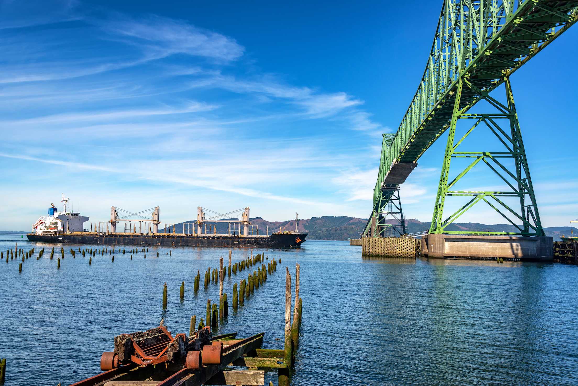 View of the Astoria Megler Bridge in Astoria, Oregon, with a tanker ship about to pass beneath it
