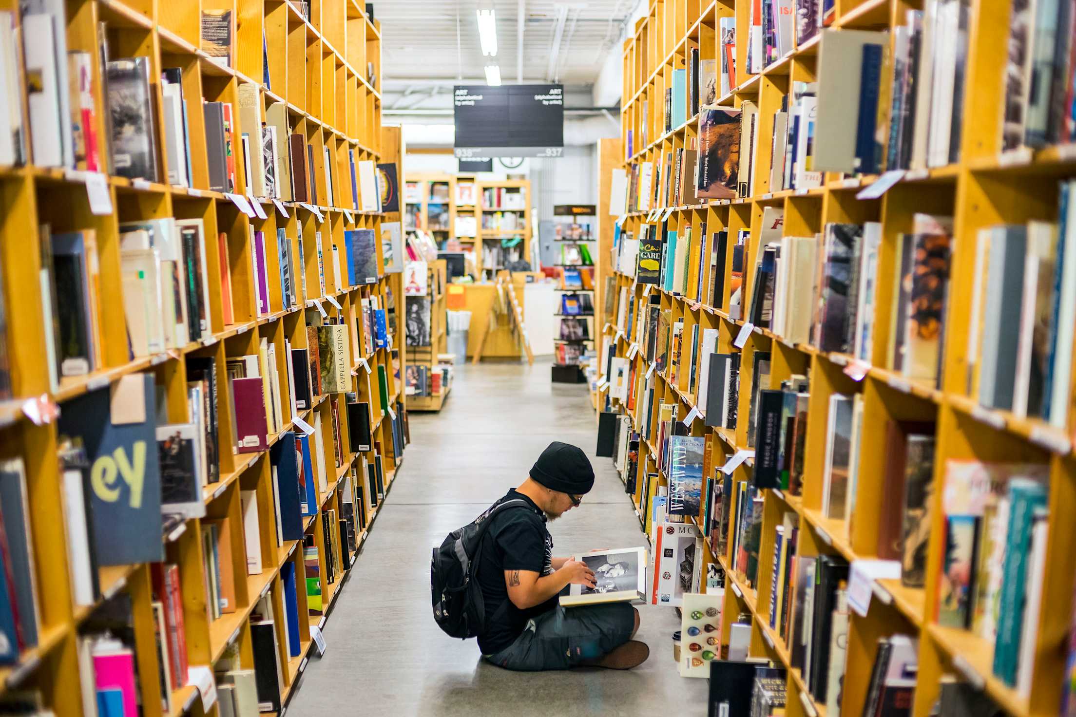 Man dressed all in black browses at Powell's Books in Portland, Oregon, picture