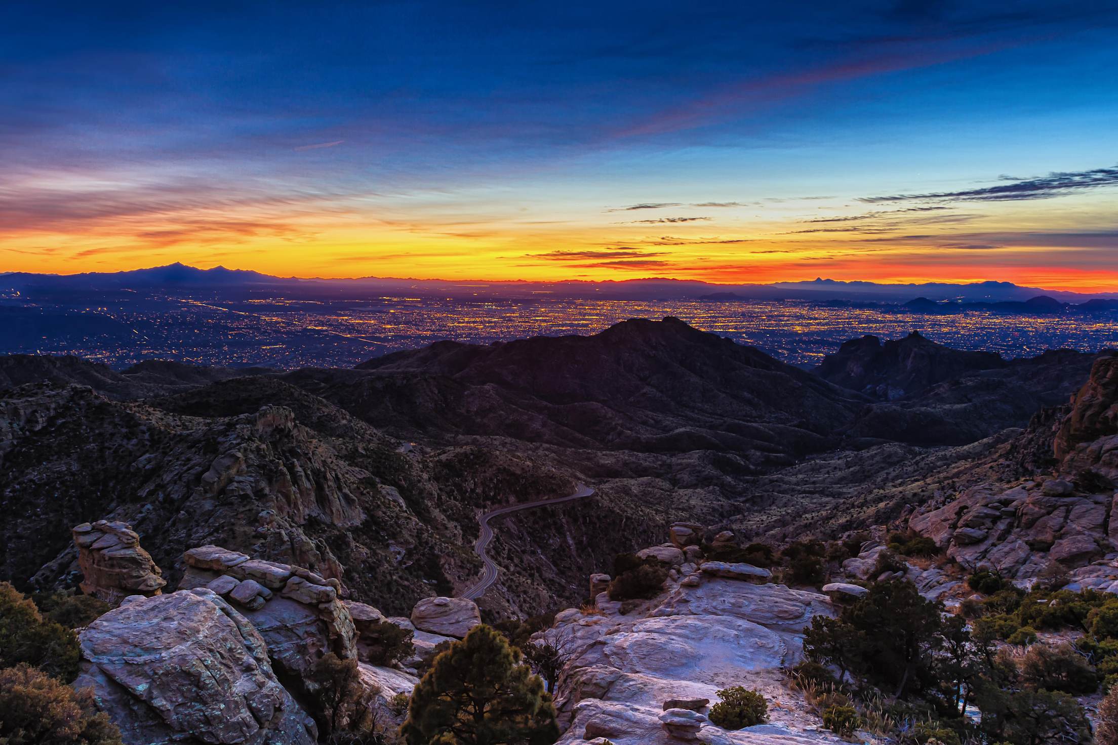 Sunset from the Catalina Mountains overlooking the city lights of Tucson, Arizona.