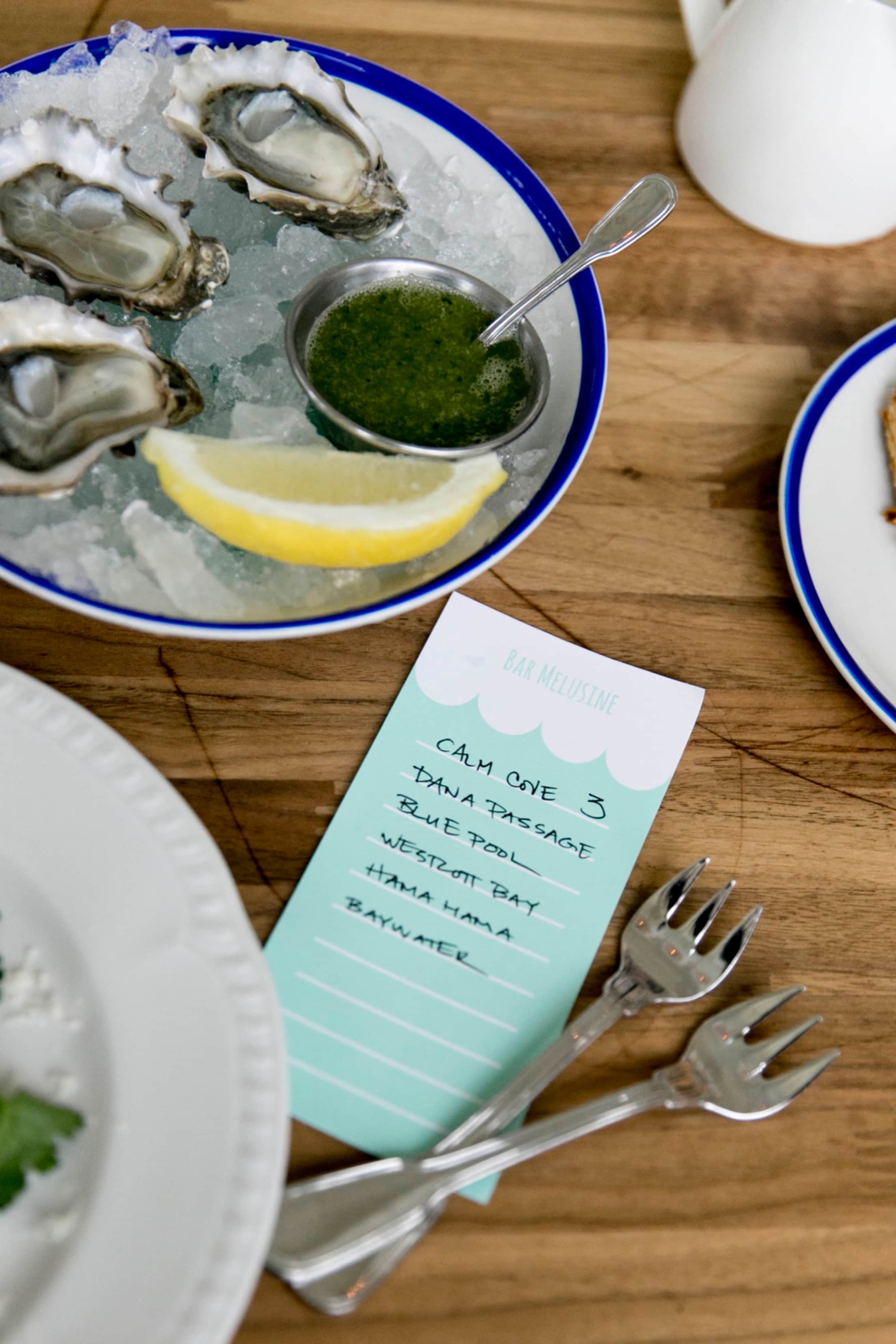 Raw oysters with mignonette on ice beckon at Bar Melusine in Seattle, WA, photo