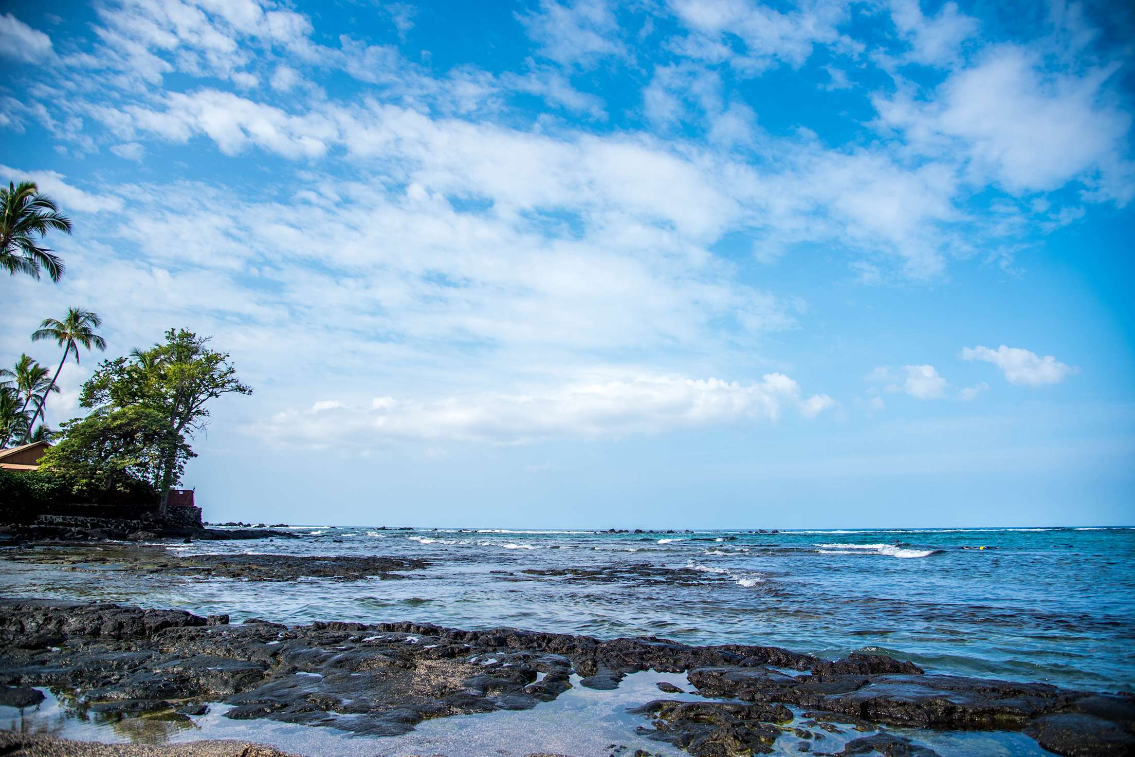 Kahaluu Beach Park with clouds and blue sky, picture