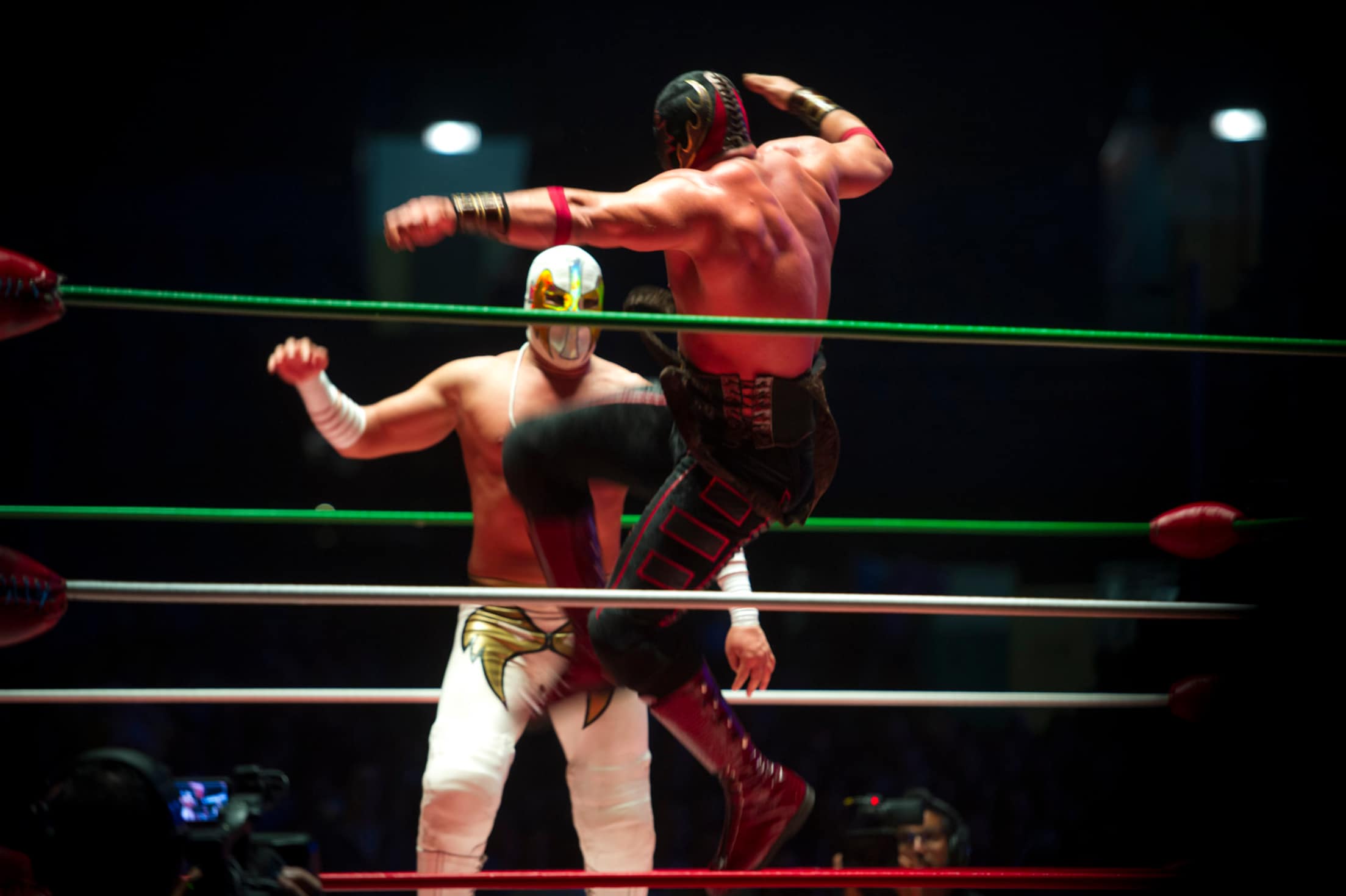 Two lucha libre wrestlers perform in the ring at Arena Mexico, photo