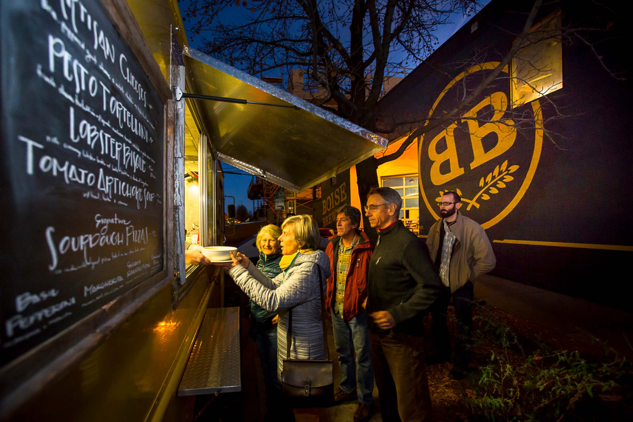 people lined up at a food truck outside Boise Brewing, picture