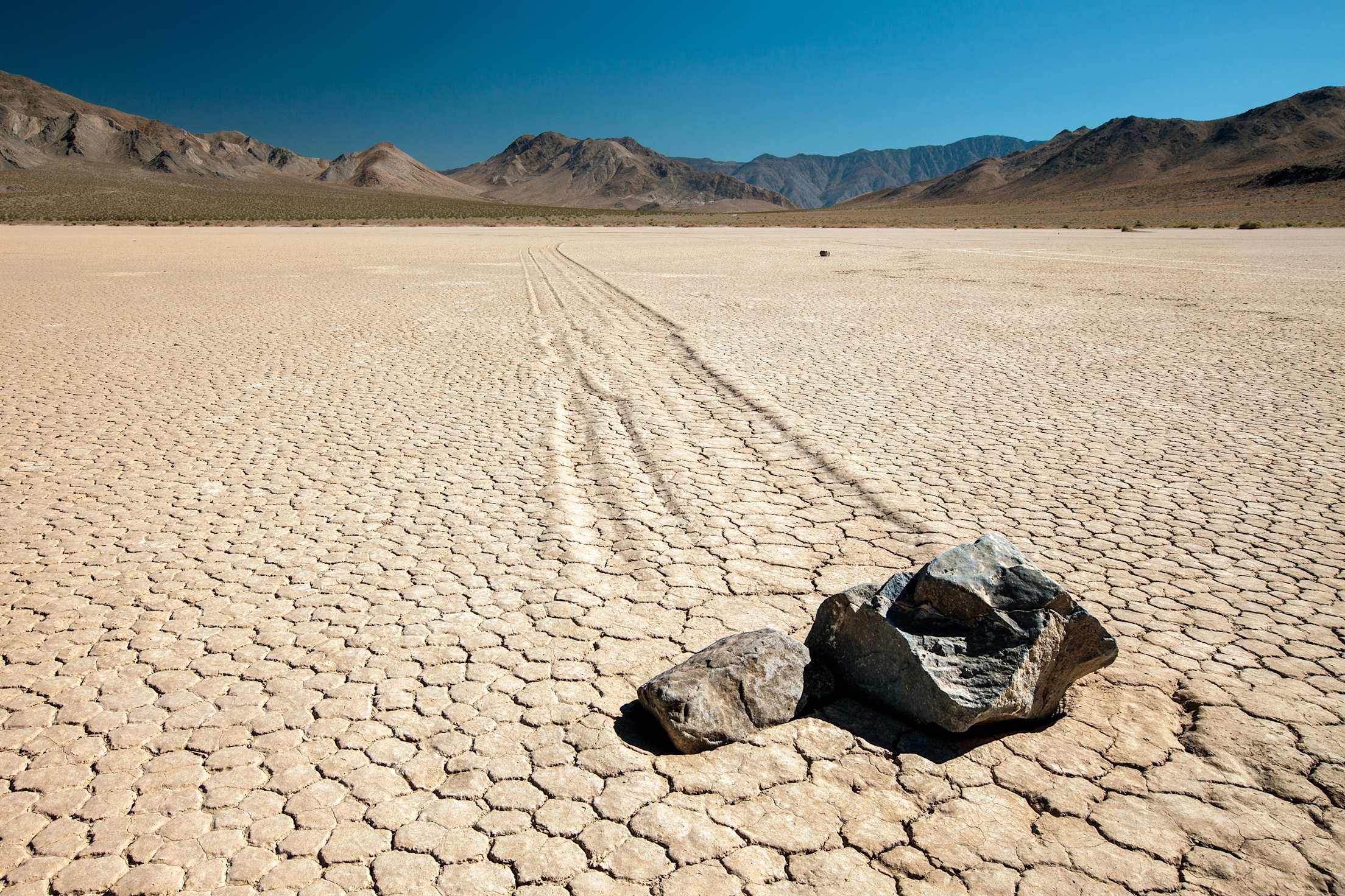 Twin rocks carve a path on Death Valley's captivating racetrack, image