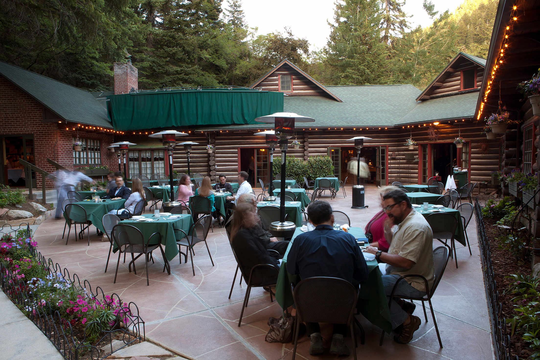 diners enjoy dinner on the cozy patio at Log Haven in Salt Lake City, Utah, picture