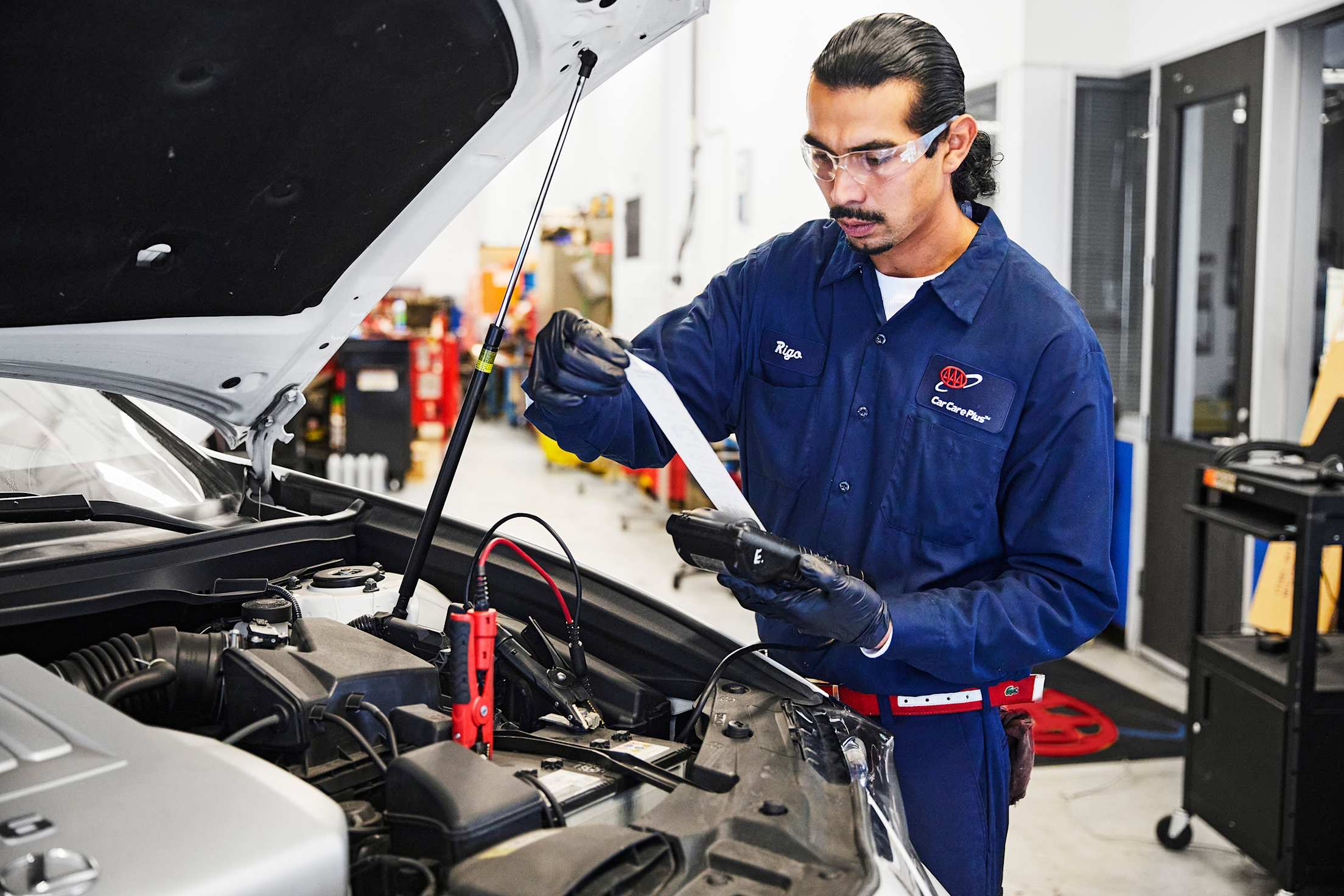 AAA Auto Repair mechanic runs battery diagnostic test.