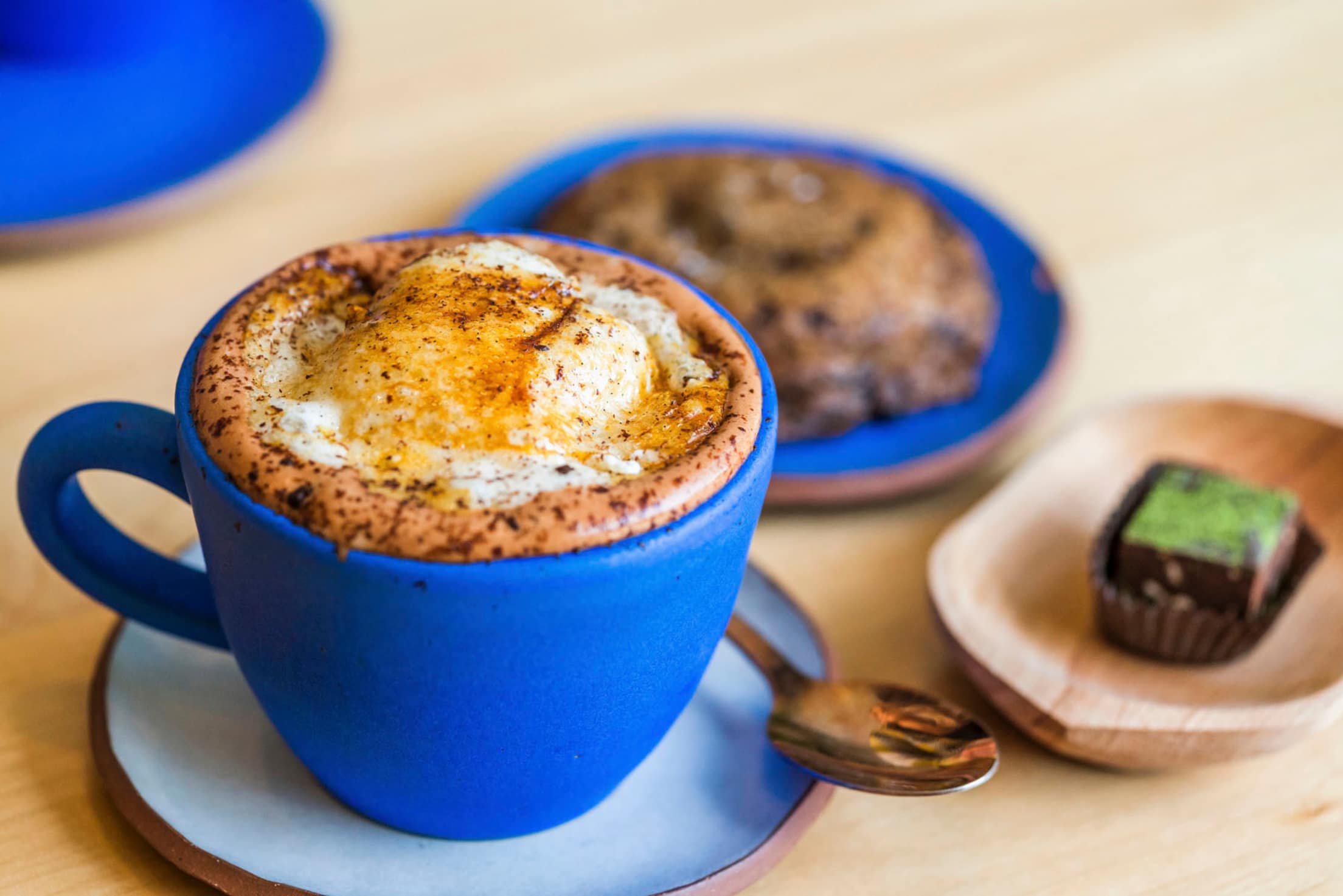 hot chocolate served in blue cup accompanied by sweet roll and chocolate treat at Cloudforest in Portland, picture