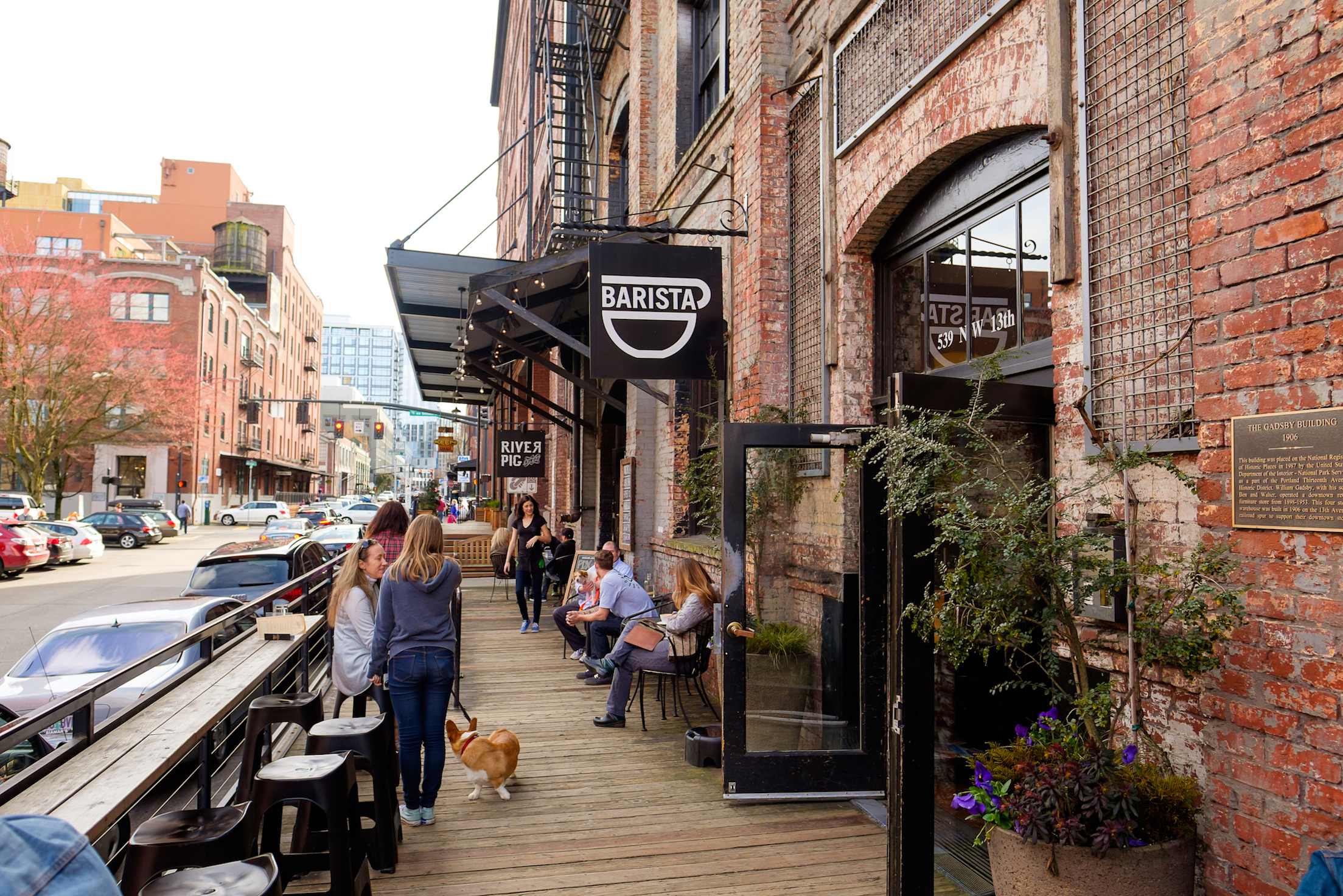 people hang out outside a coffee shop in a brick building Portland, Oregon