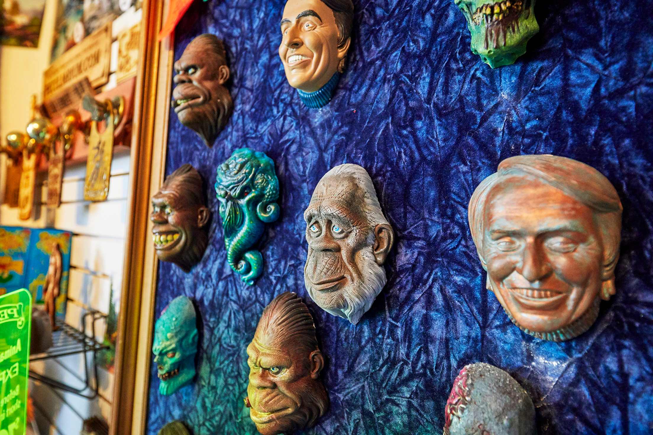 masks by artist Colin Batty grace a wall at the Freakybuttrue Peculiarium, in Portland Oregon's Northwest District