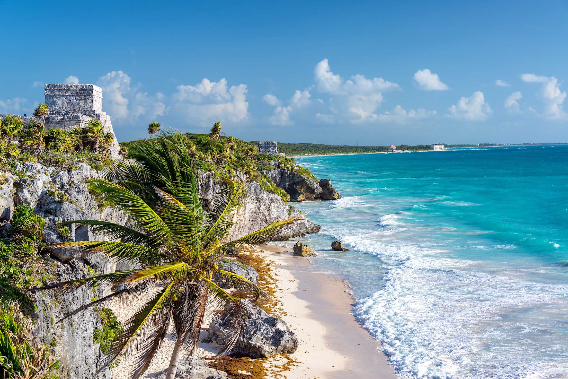 Maya ruins overlooking a white sand beach on Mexico's Riviera Maya.
