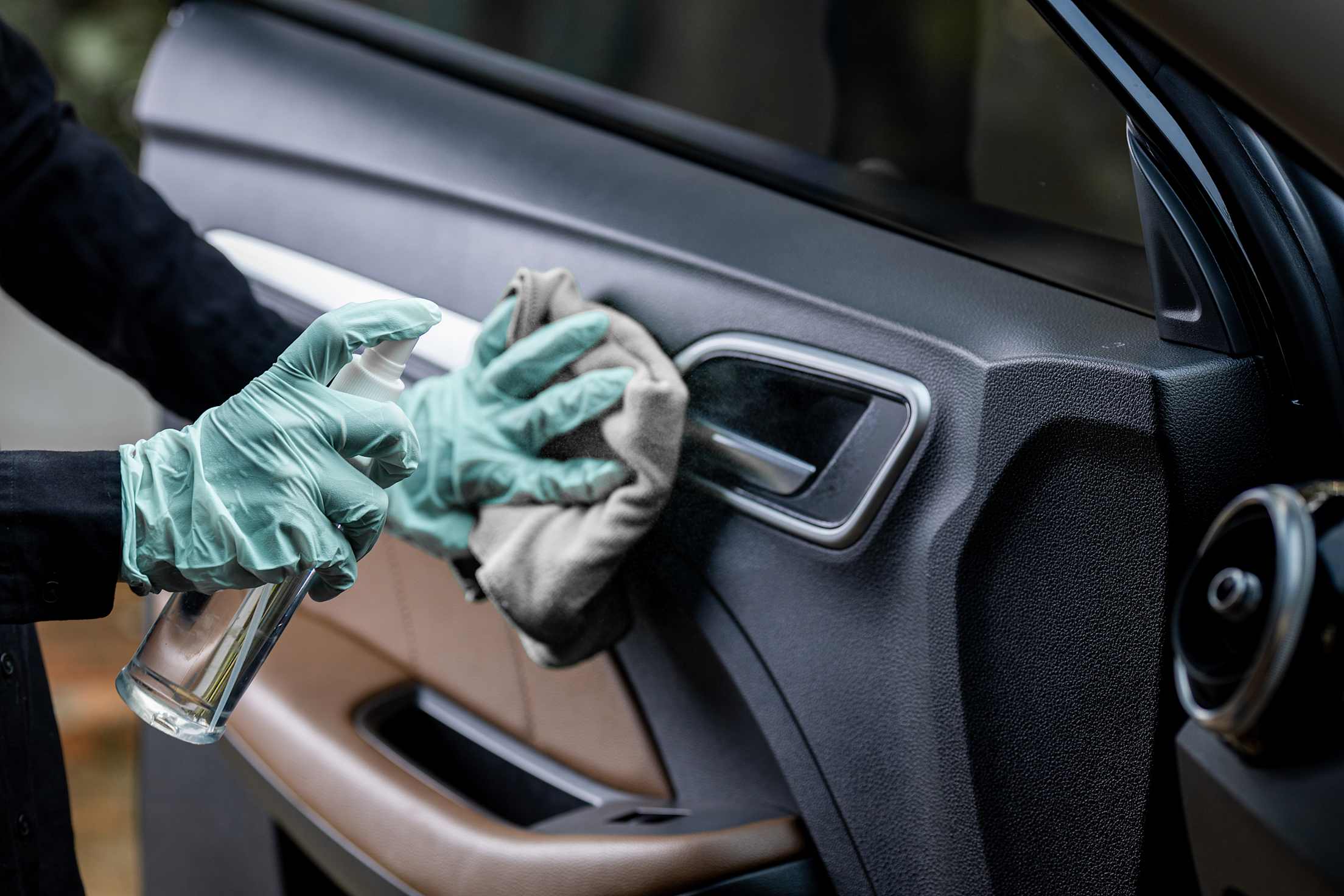 AAA Member cleans car door handle.
