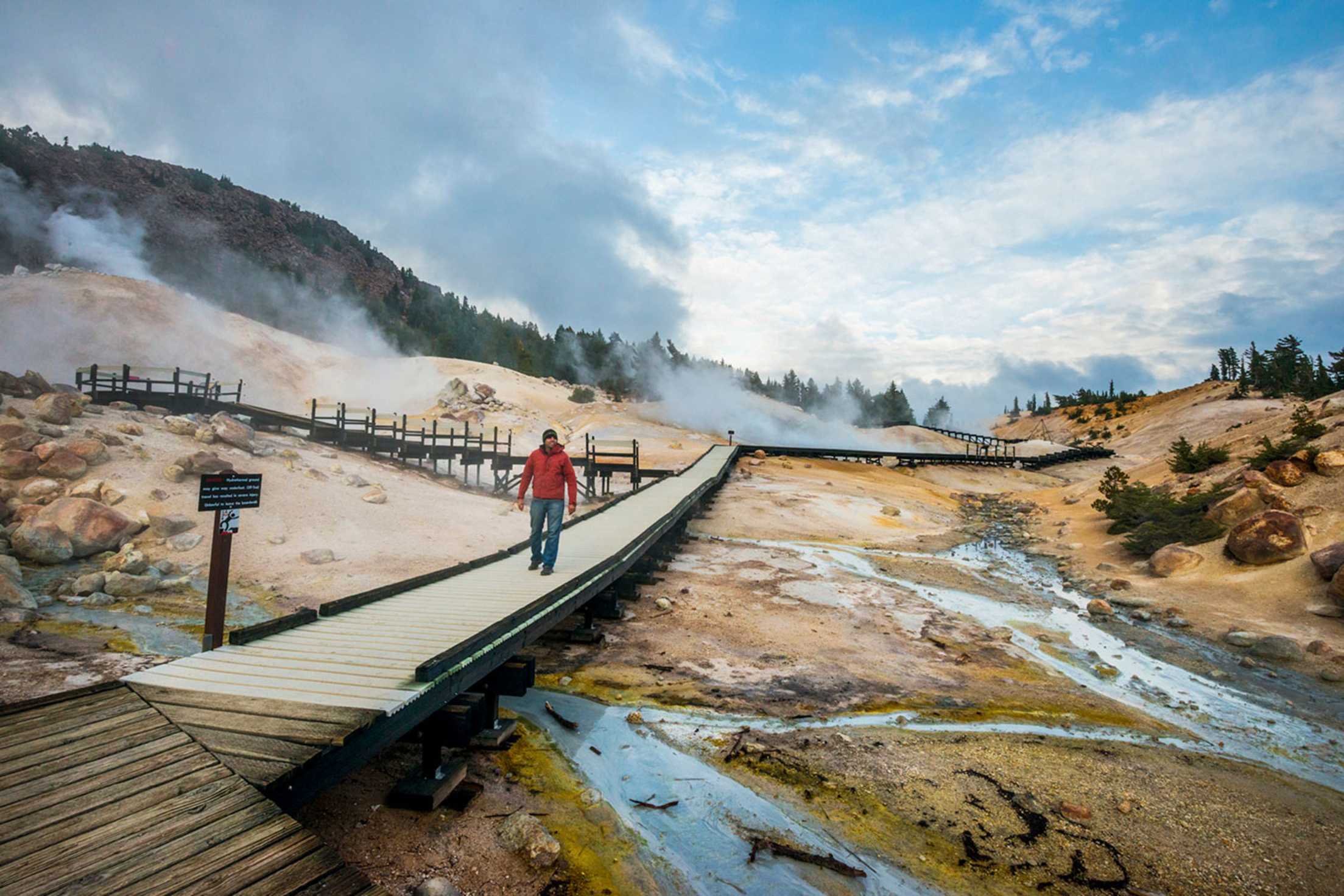 park visitor on boardwalk at Bumpass Hell in Lassen Volcanic National Park, California
