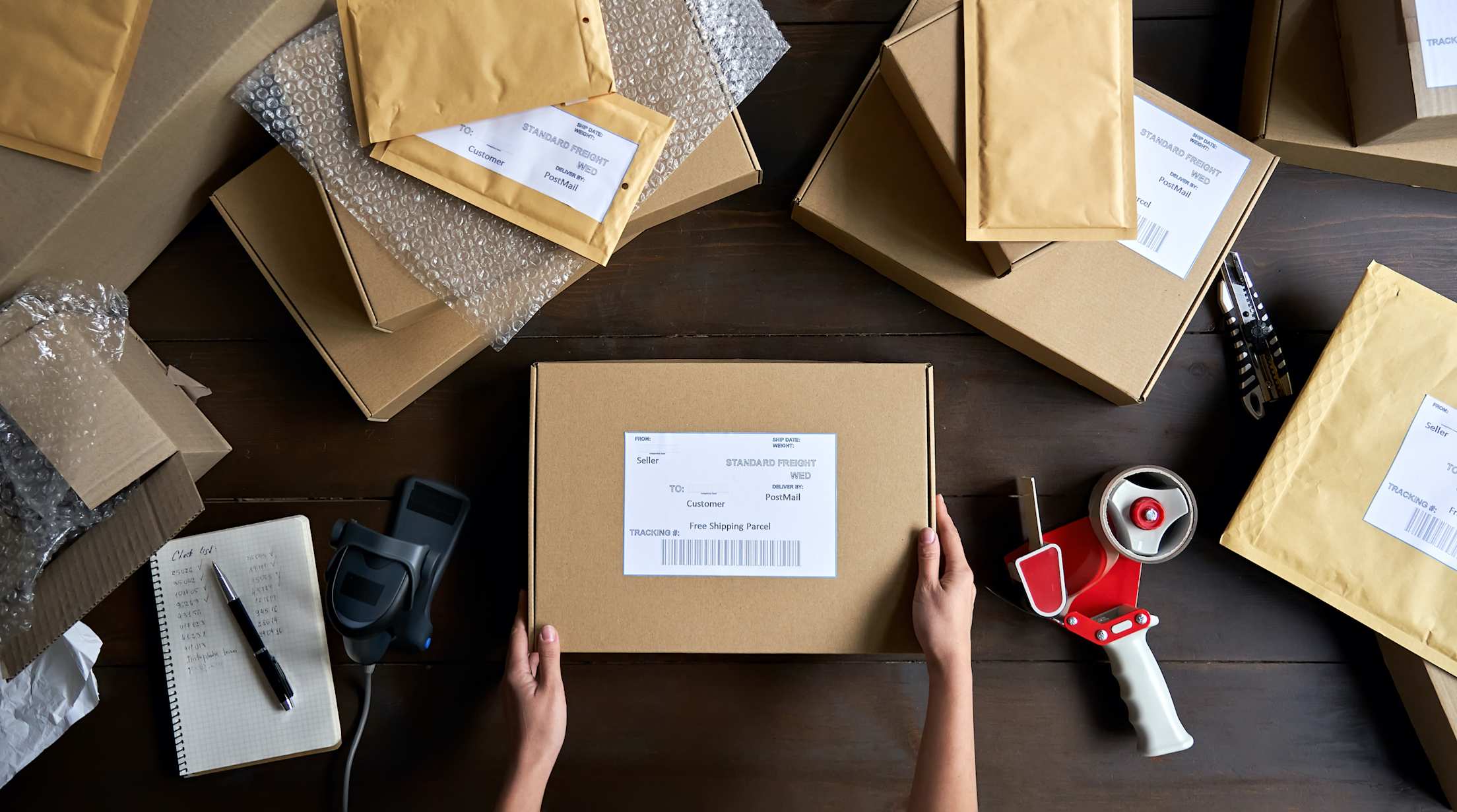 package in the middle of table with packing supplies surrounding it