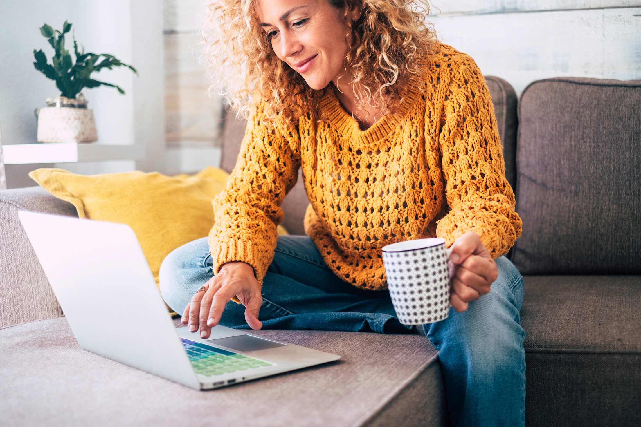 AAA Member completes DMV services online while sitting on the couch.