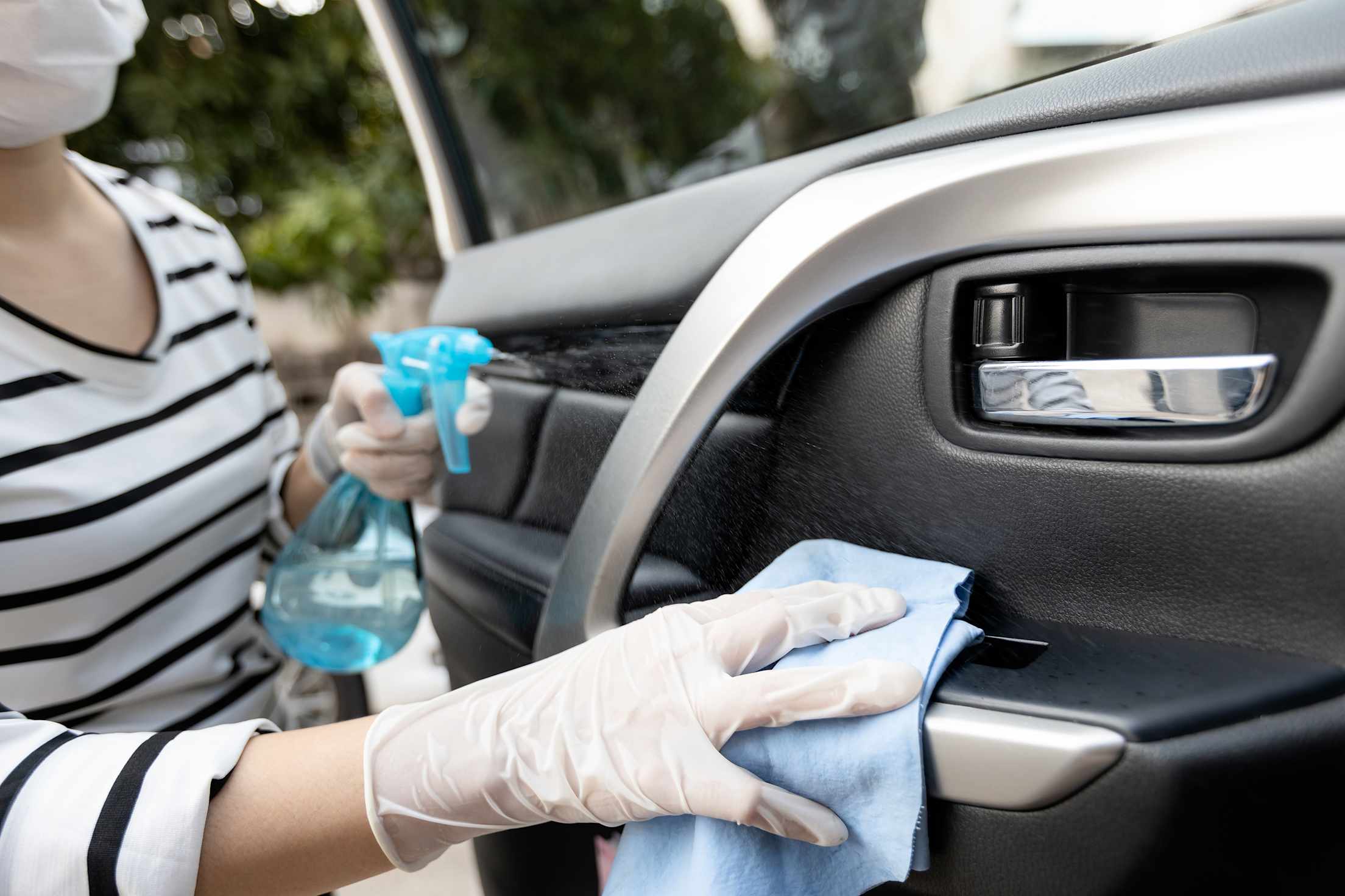 AAA Member cleans her door handle with rubbing alcohol.