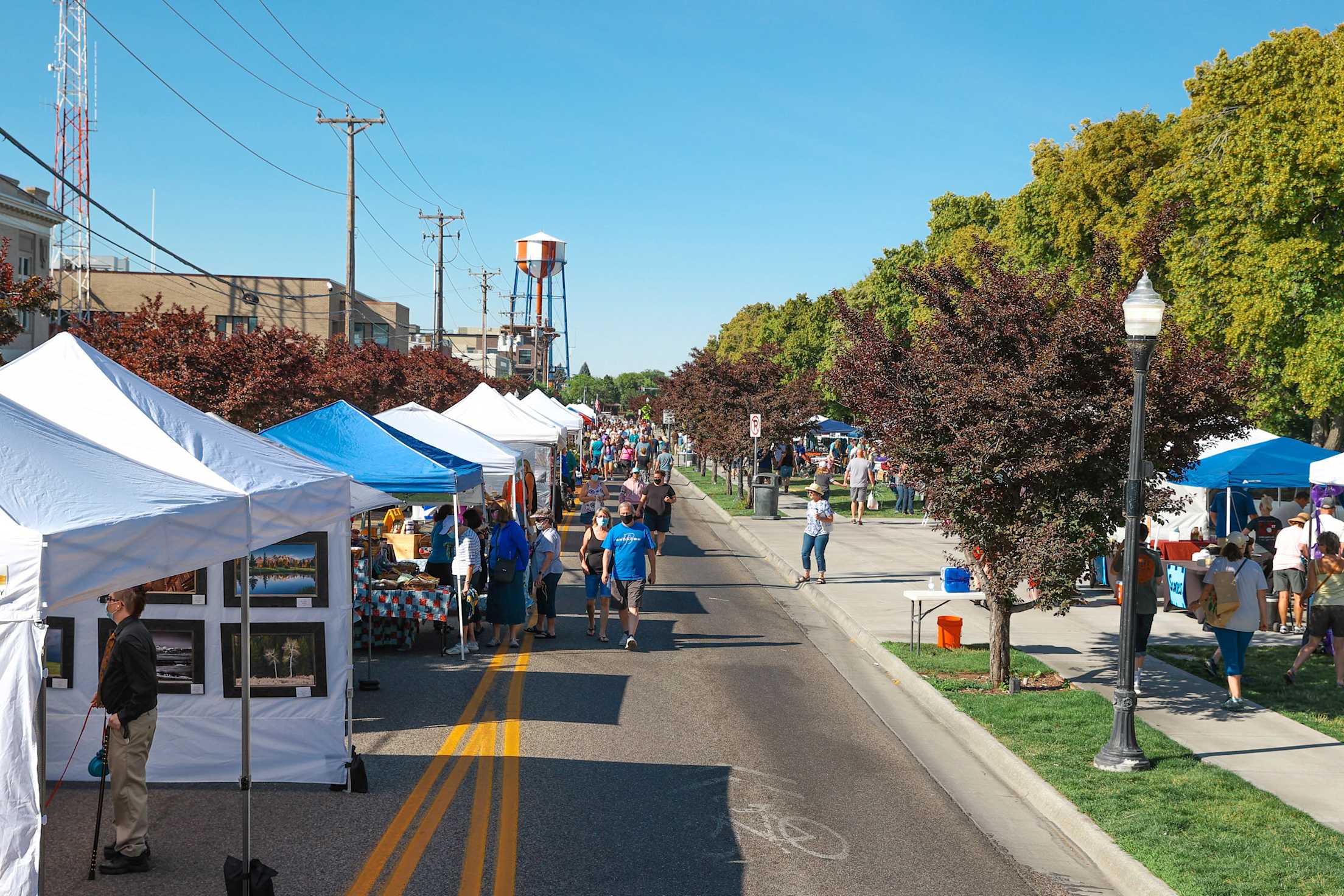 People browse booths at Idaho Falls Farmers Market on Memorial Drive.