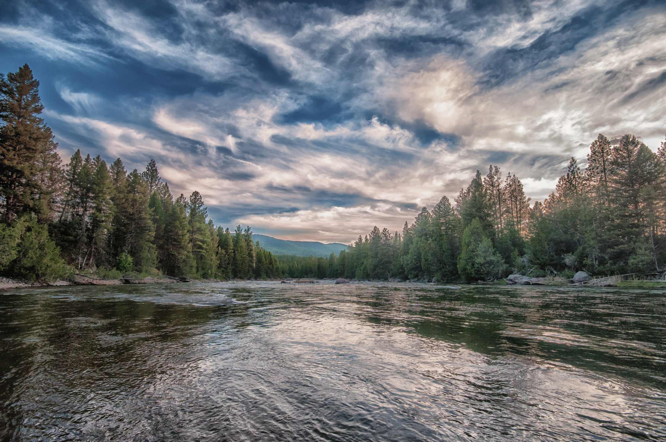 Clouds dance across the Blackfoot River in Montana.