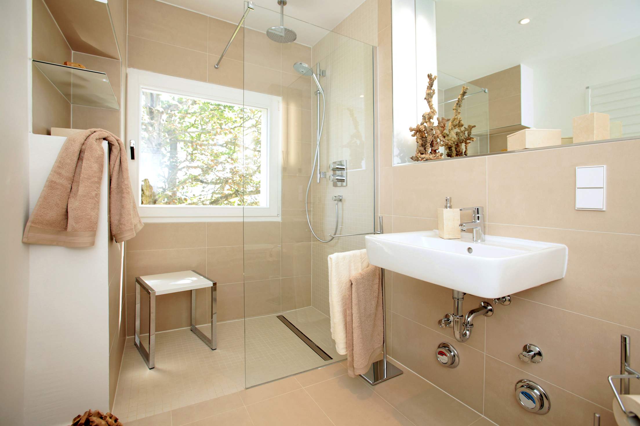 A modern curbless shower with a shower stool.