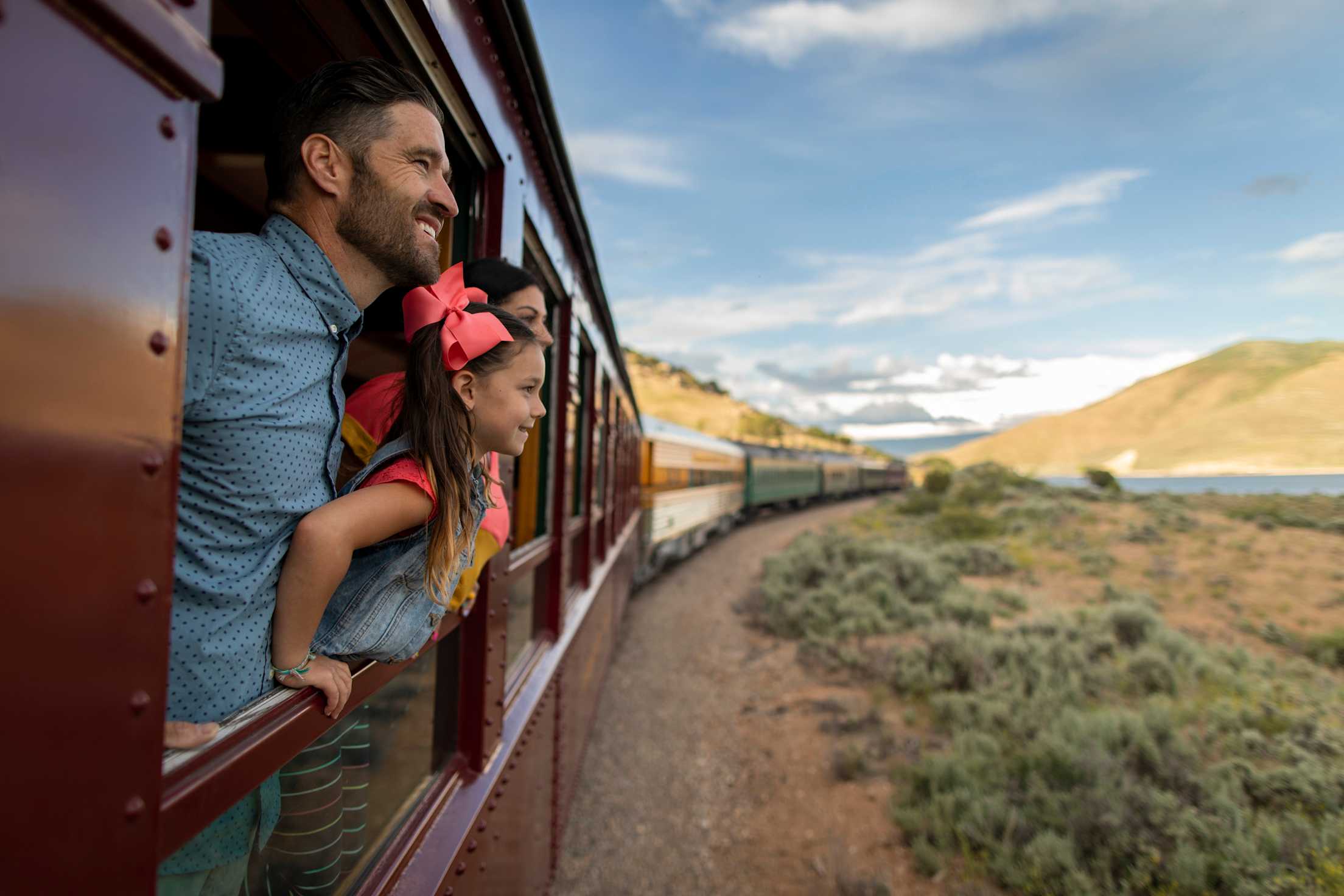 A family of three rides on the Heber Valley Railroad.