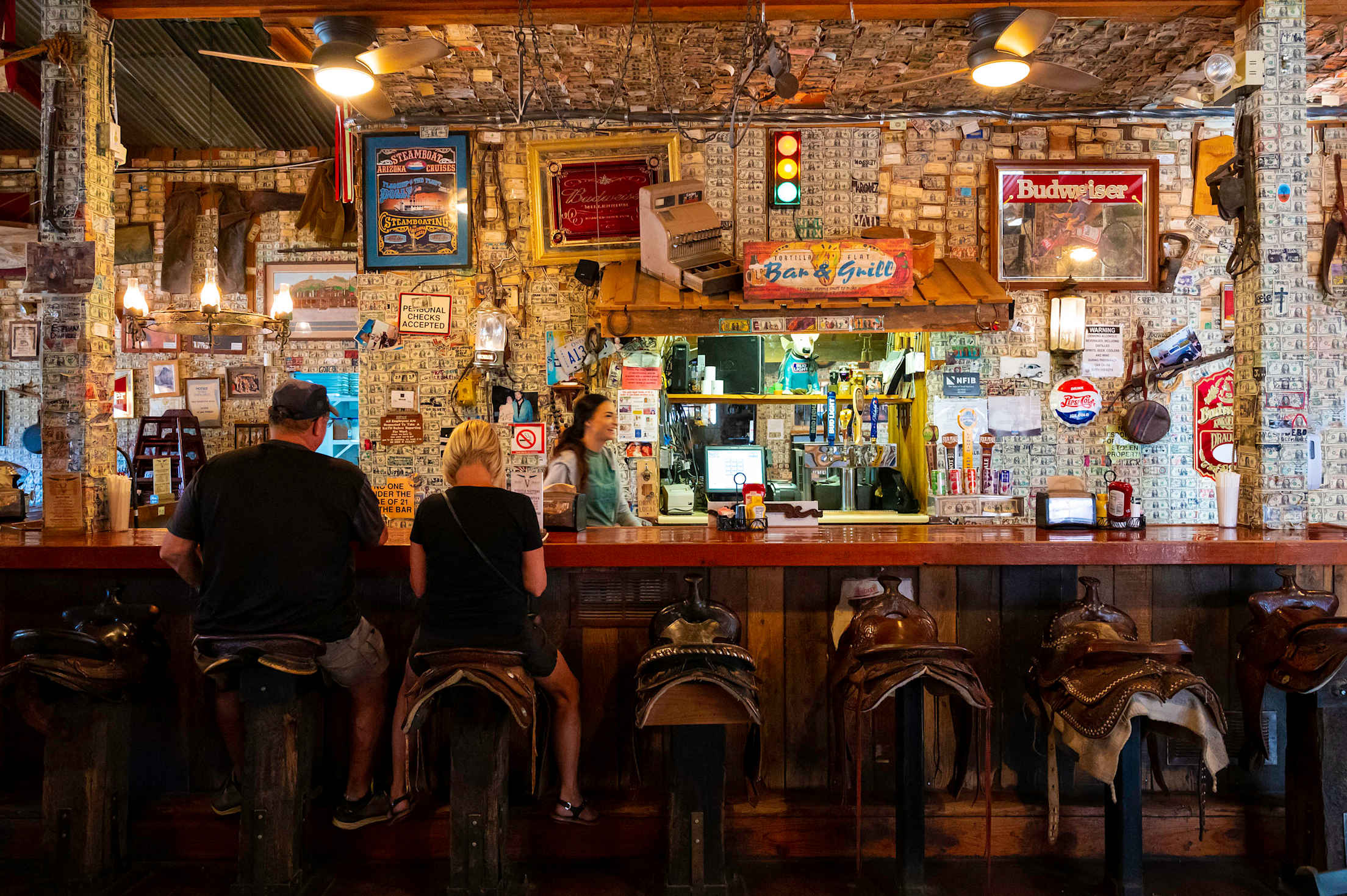 Signed dollar bills line the walls behind the bar at Superstition Saloon & Restaurant.