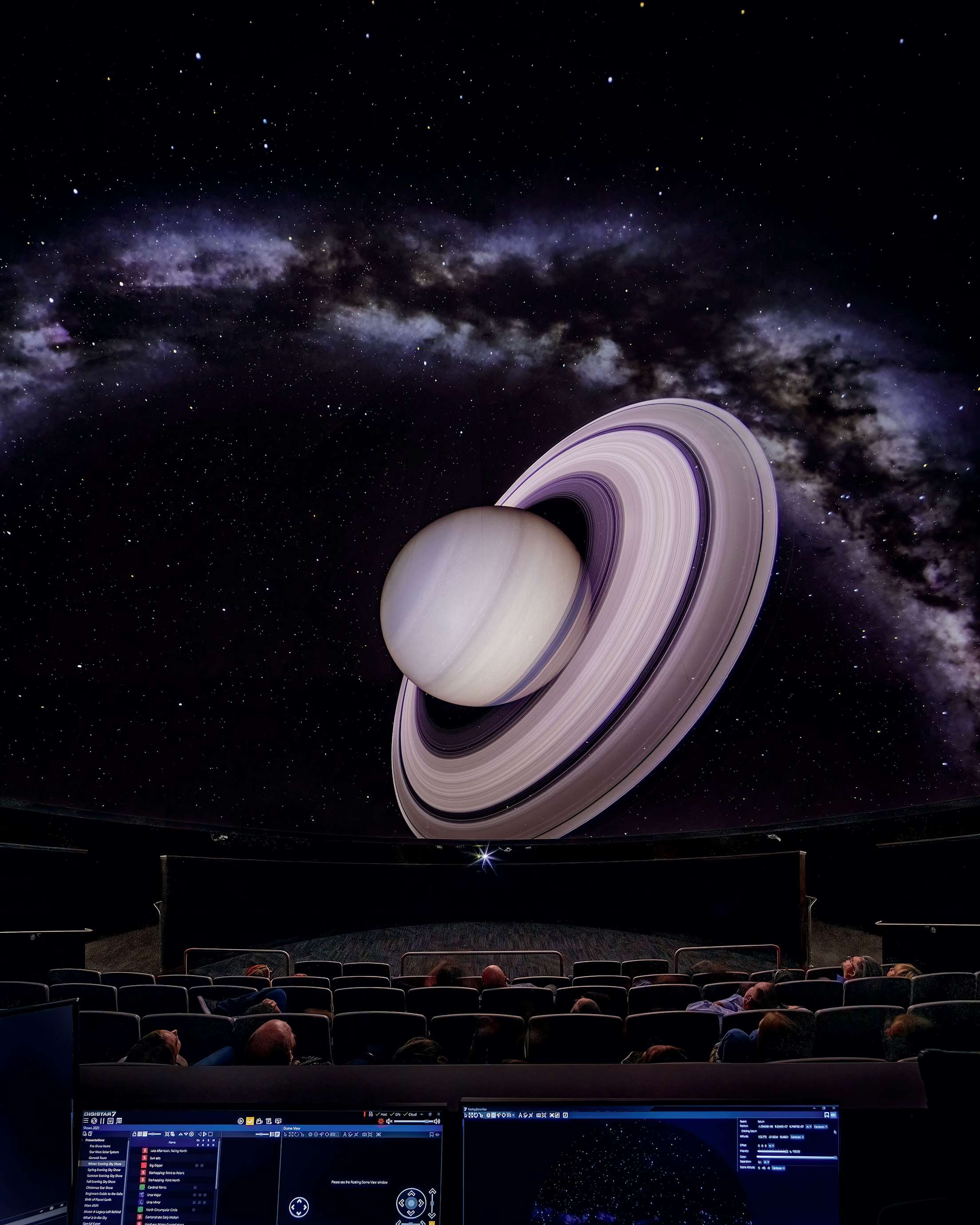 People watch a planetary tour inside the Christa McAuliffe Space Center's planetarium.