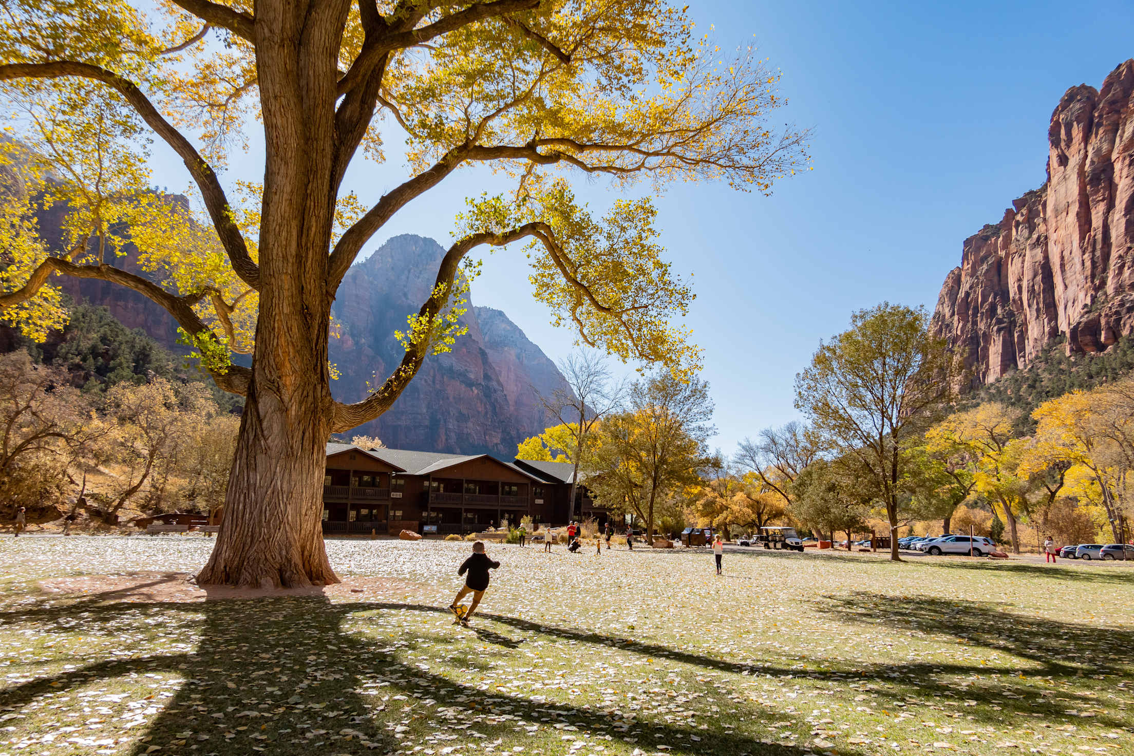 A child plays soccer in front of Zion National Park Lodge.