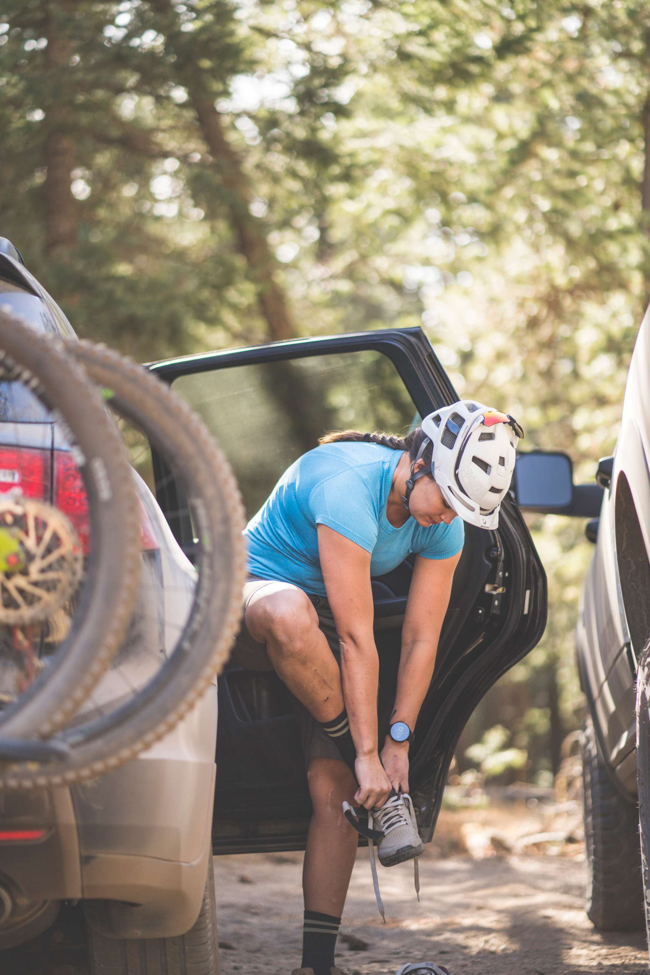 Professional mountain biker Alex Pavon puts on her shoes and gets ready to ride on her local trails around Flagstaff, Arizona.