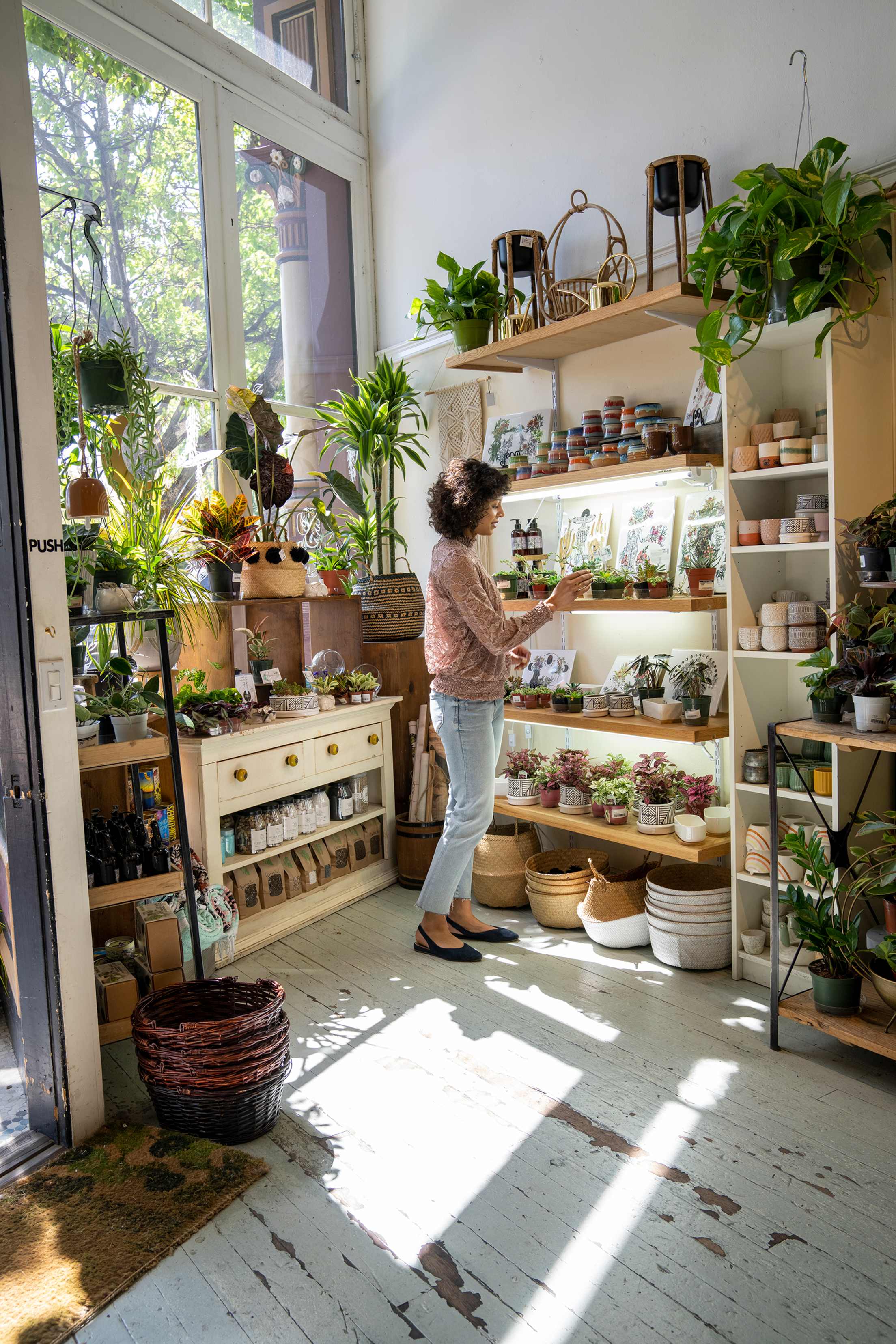 A woman browses the houseplants inside Flourish, a shop in Petaluma, California.