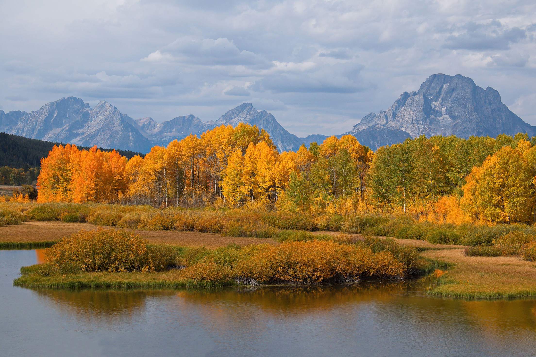 Orange trees surround Jenny Lake in Wyoming's Grand Teton National Park.