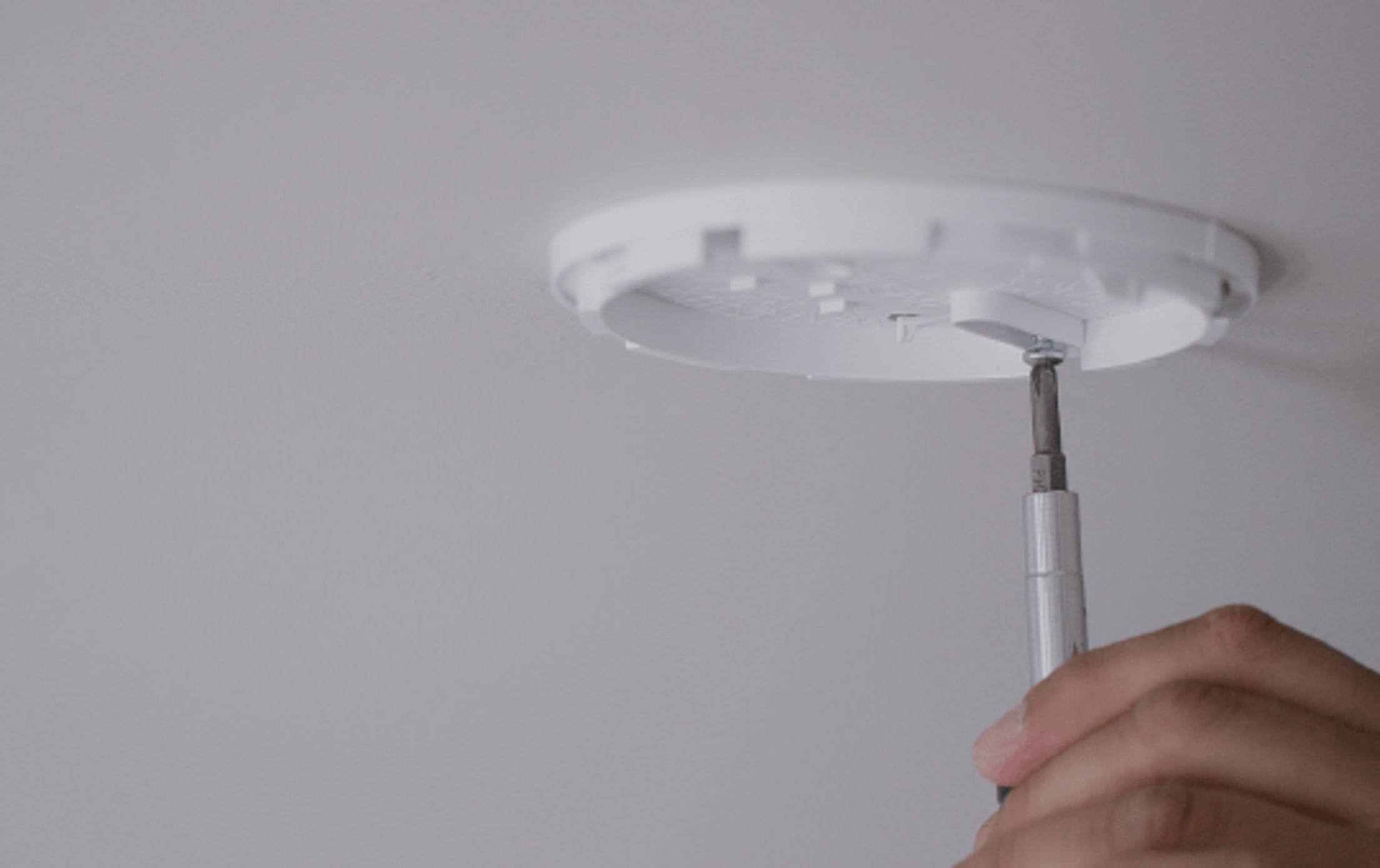 attaching the carbon monoxide detector to the ceiling