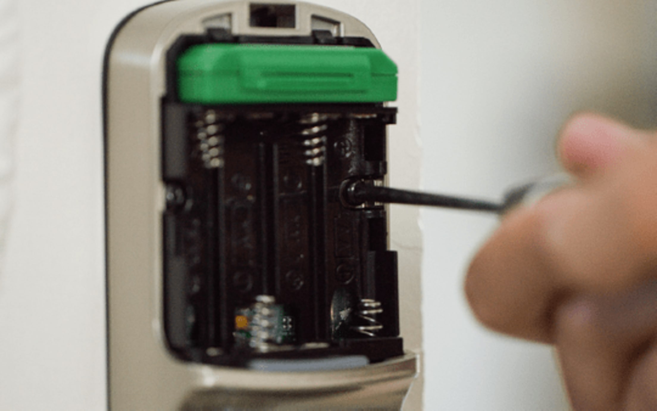 Secure the lock to the wall with a machine screw