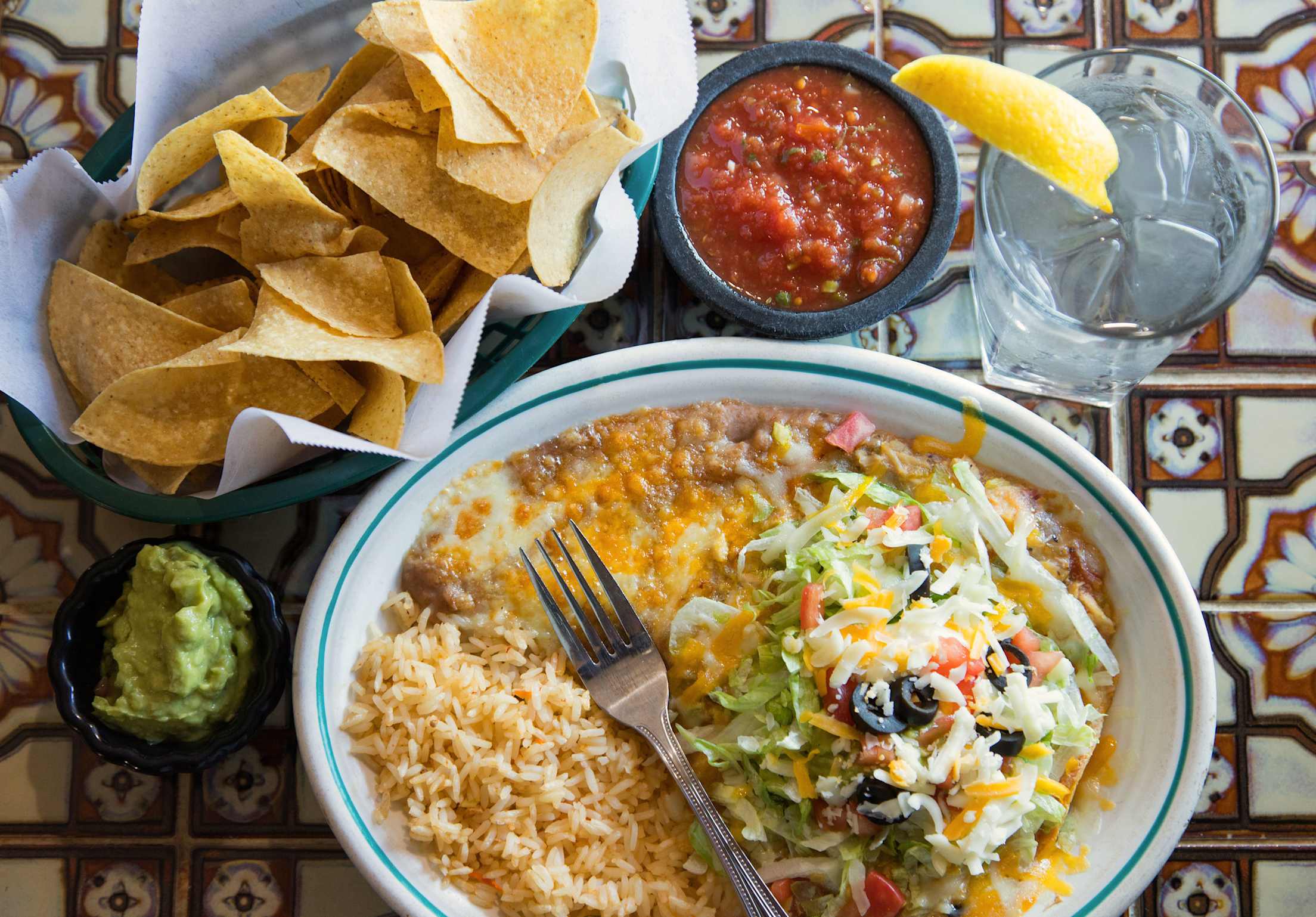 Joe Bandito's chicken tostada on a table with chips and salsa in Springville, Utah.