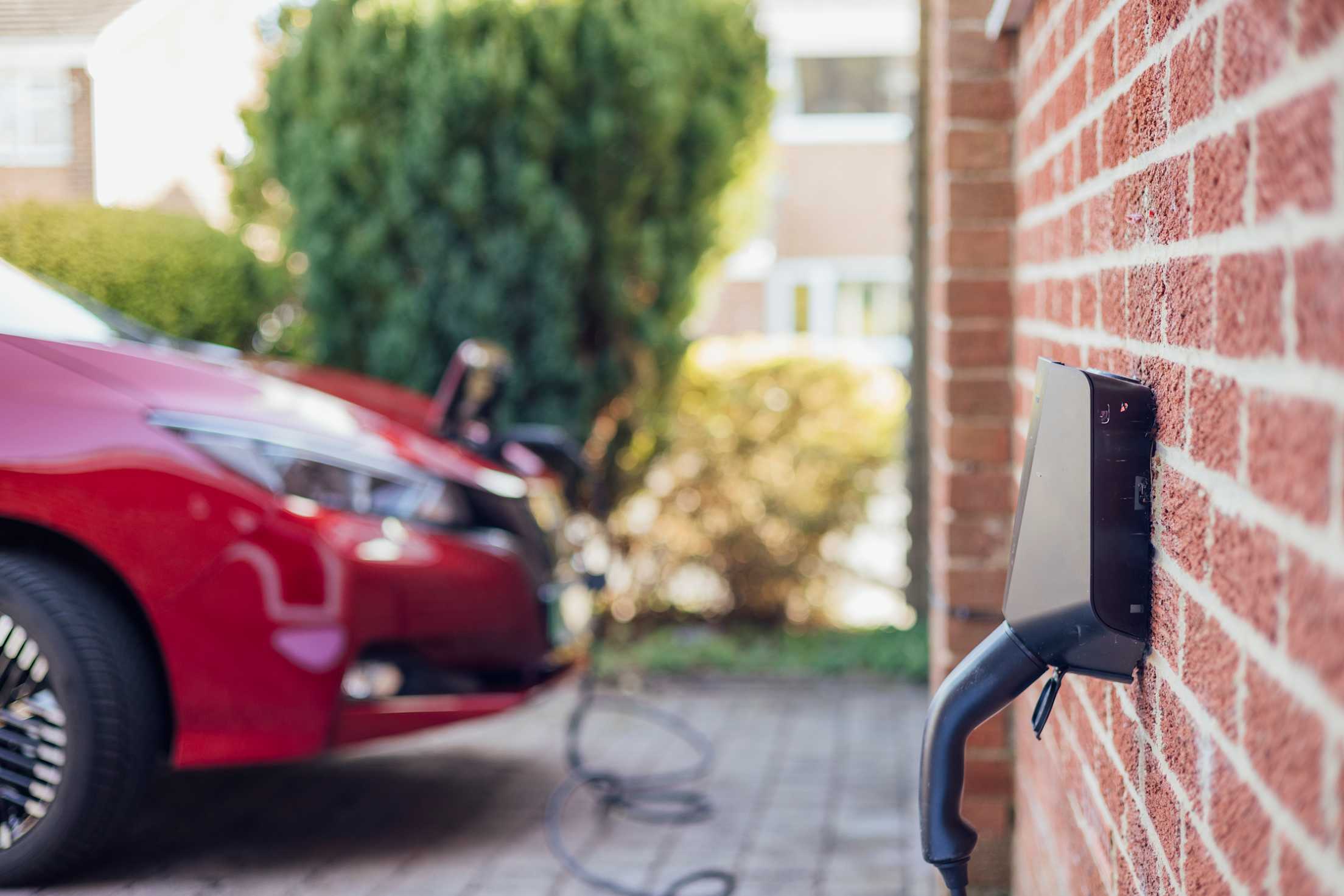 Red Ev charging at in driveway