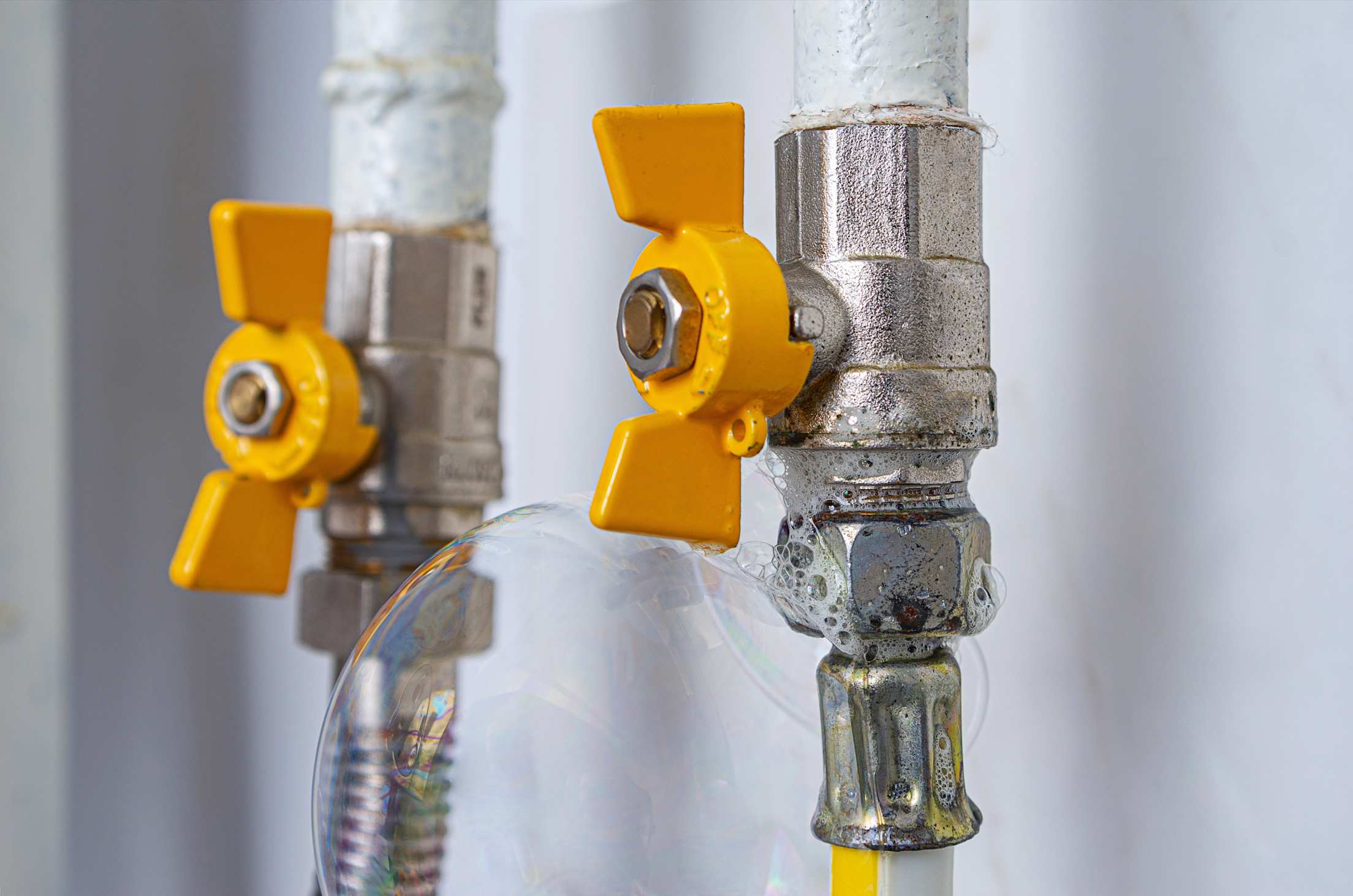 Soapy water bubbles on a gas line.