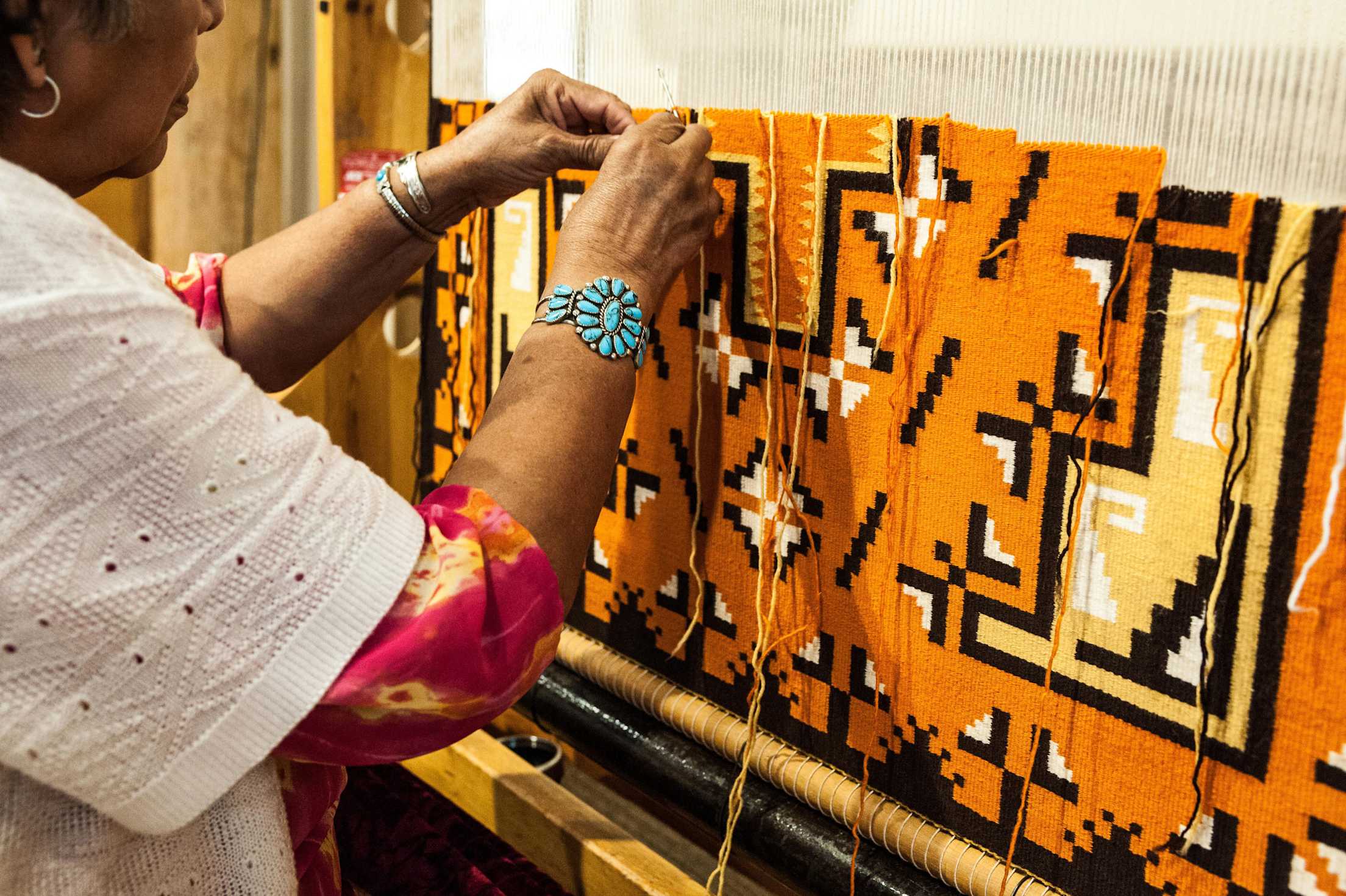 A woman weaves at Hubbell Trading Post in Ganado, Arizona.