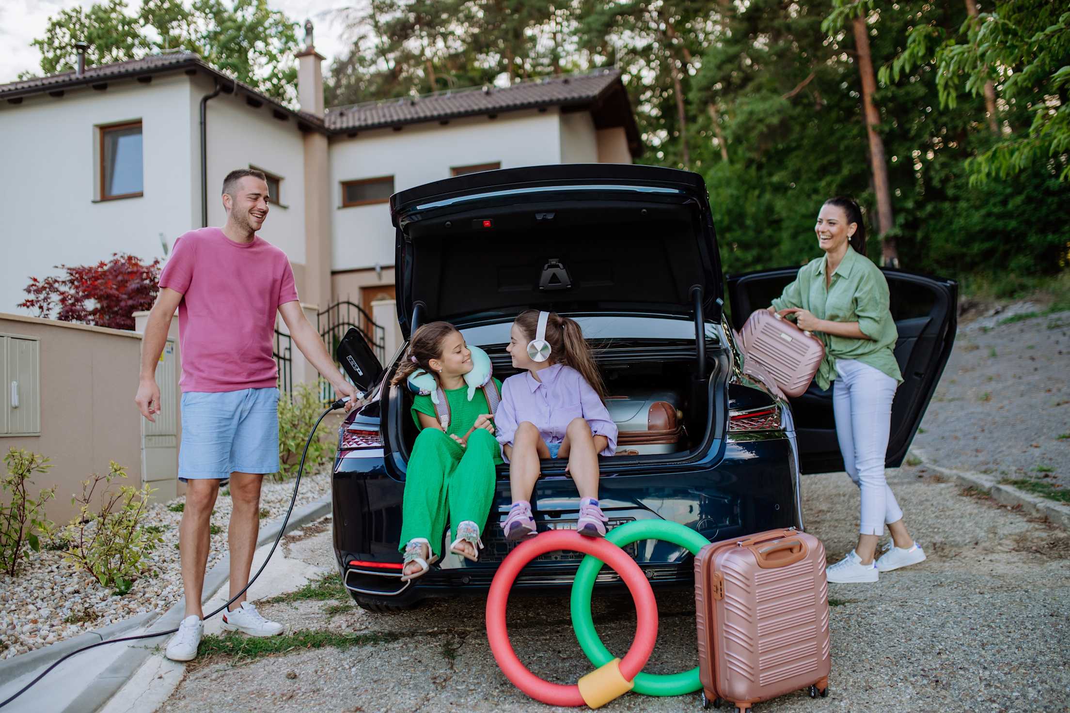 A family packs their Tesla for a road trip.