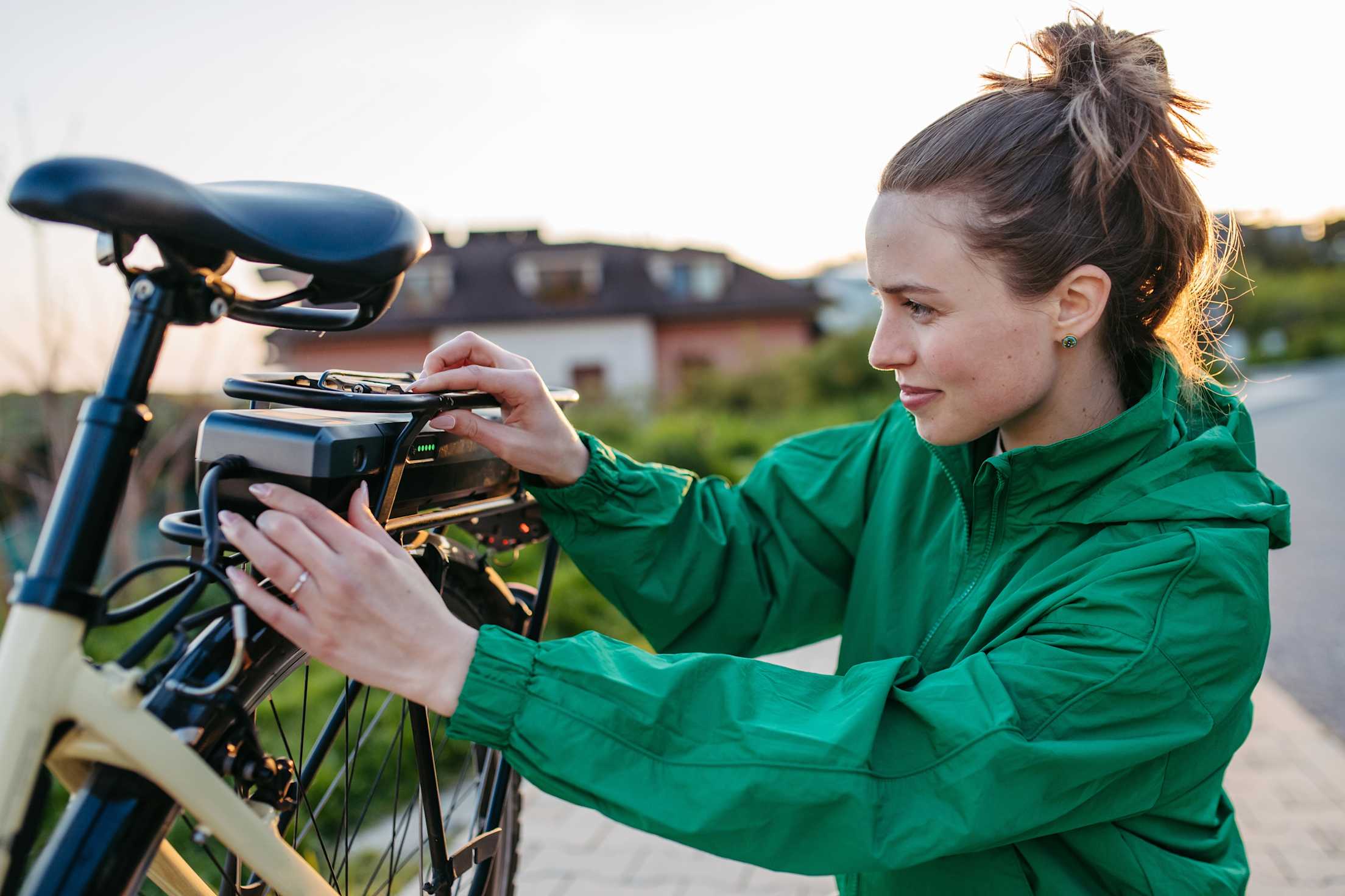 A woman checks the charge on her e-bike battery.