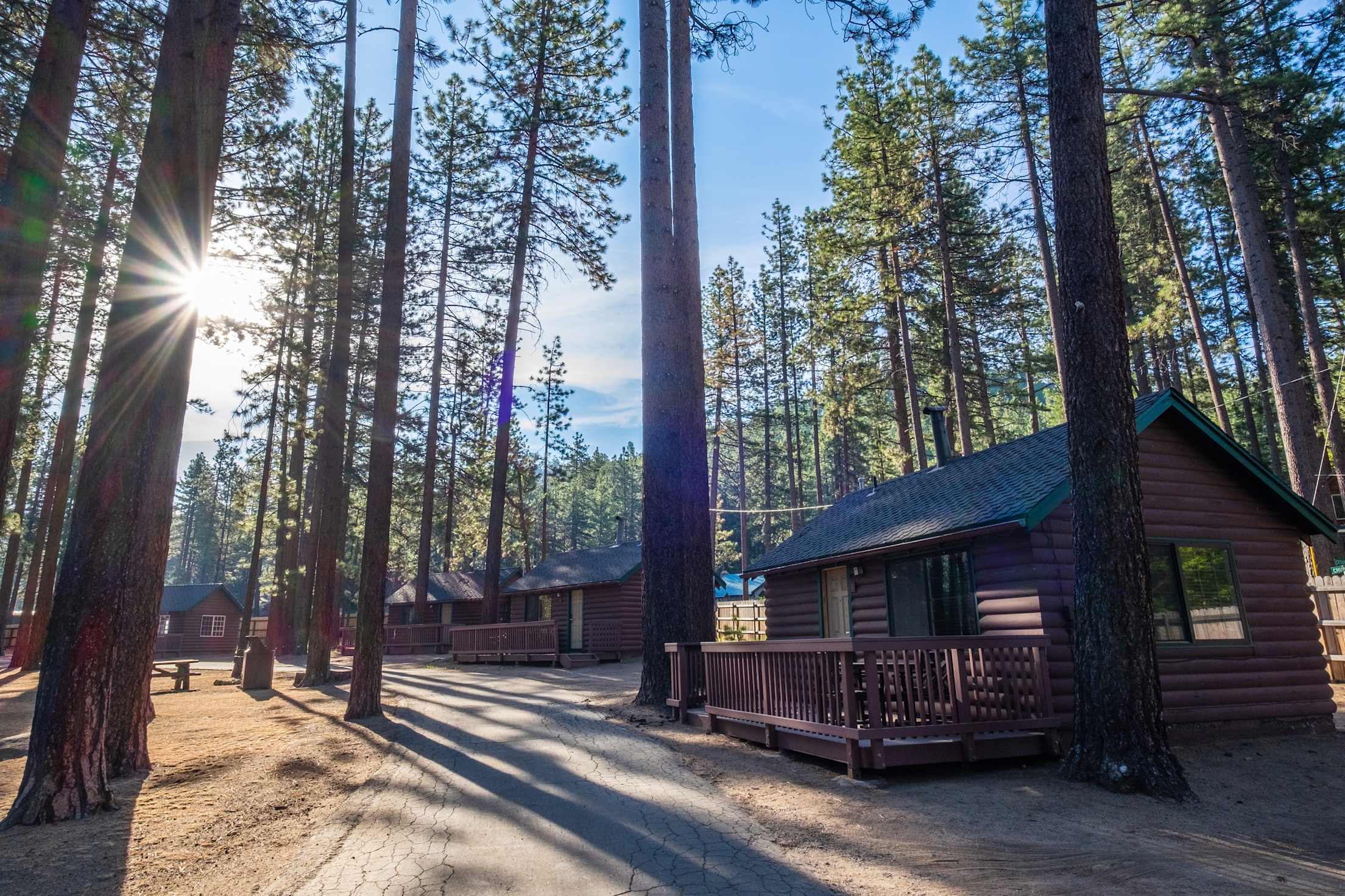 Cabins stand under tall trees at Camp Richardson Resort near California's Lake Tahoe.